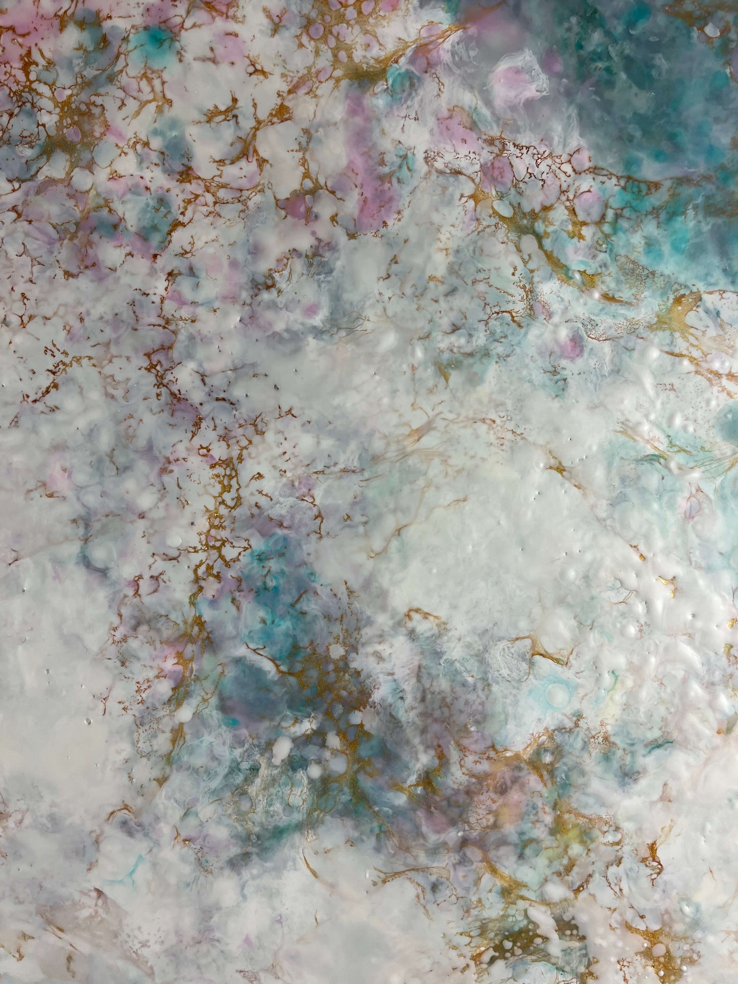 Close up. This abstract painting has a calming feel to it with blue greens, white, pinks and gold. it creates an ethereal feeling with the what looks like a magical cloud floating by.