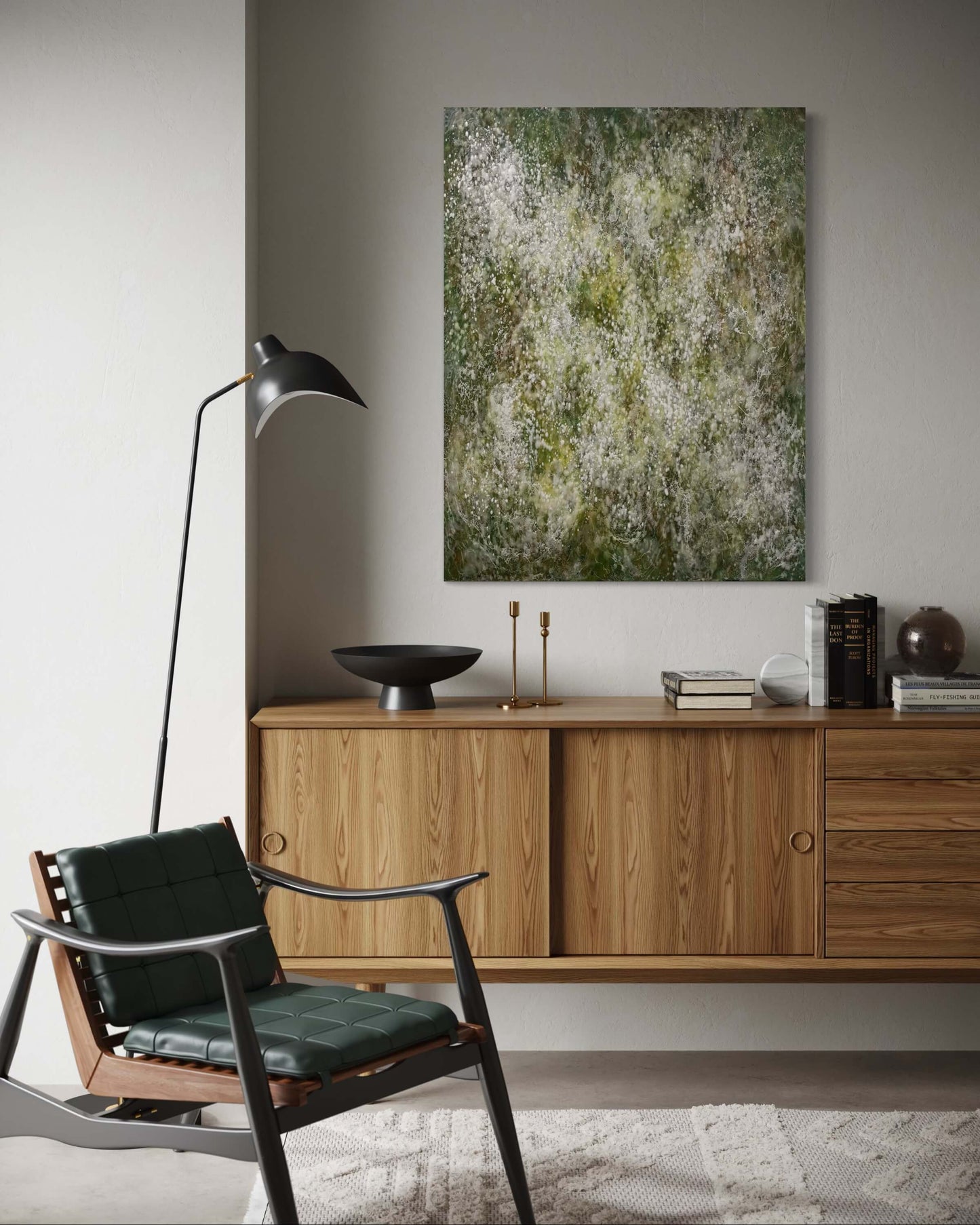 Original abstract encaustic painting with delicate layers of soft white, mossy green and earthy tones. The surface is textured with fine, mist like dots, and organic forms, evoking a sense of gentle movement, growth, and natural stillness displayed above a credenza in a modern interior