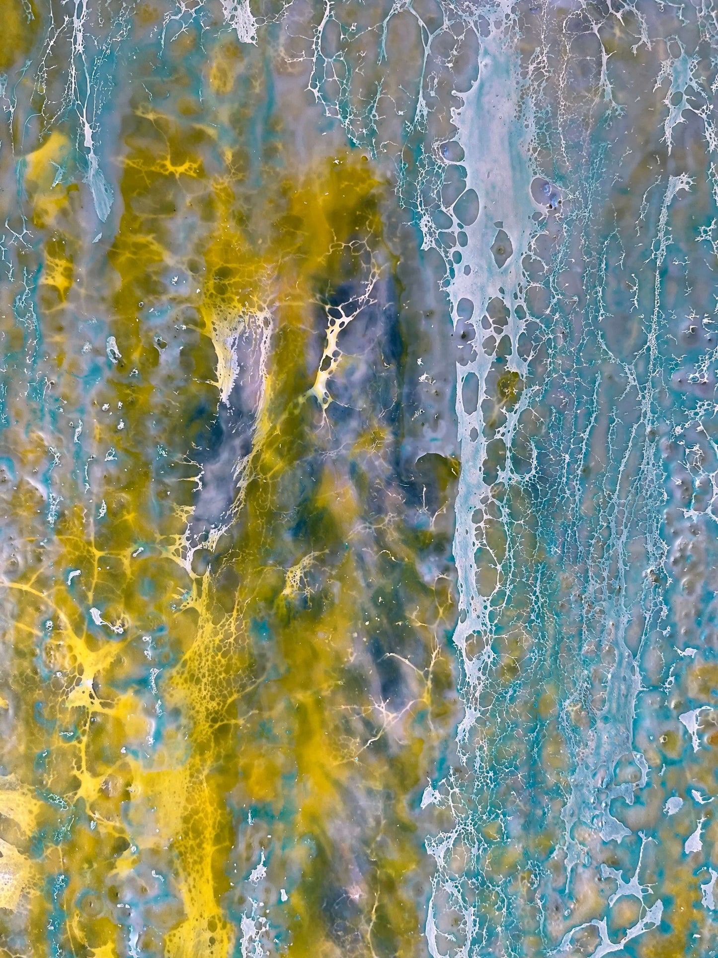 Close up.This abstract painting is reminiscent to me of a wall of an old building that has been weathered with humidity and sun. The greens and yellows are like moss that has developed on the plaster where blue paint has cracked and been peeling.