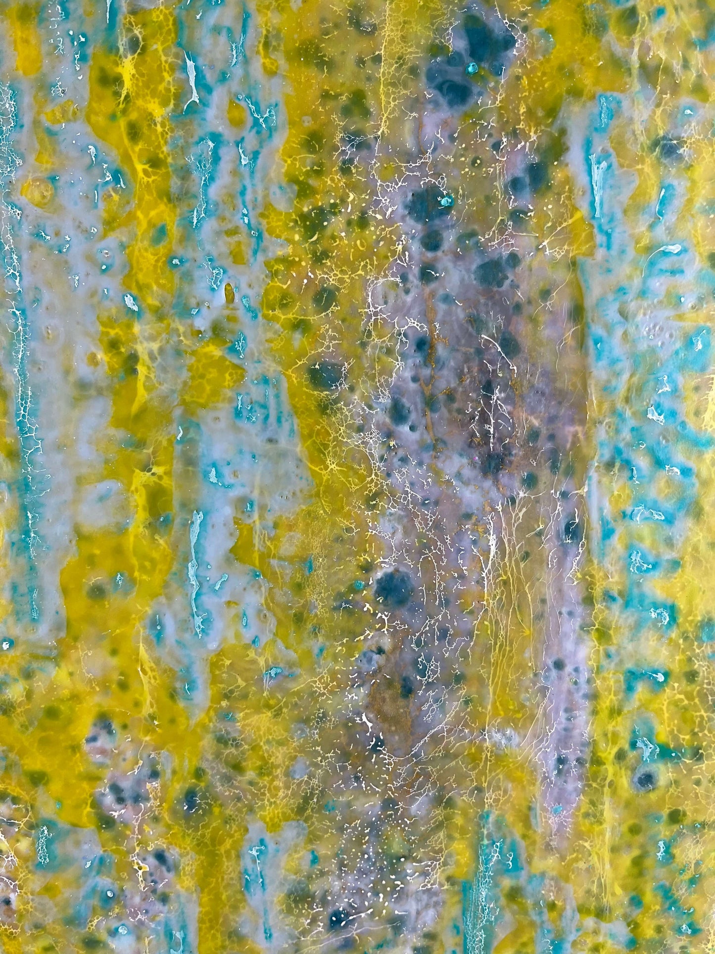 Close up.This abstract painting is reminiscent to me of a wall of an old building that has been weathered with humidity and sun. The greens and yellows are like moss that has developed on the plaster where blue paint has cracked and been peeling.