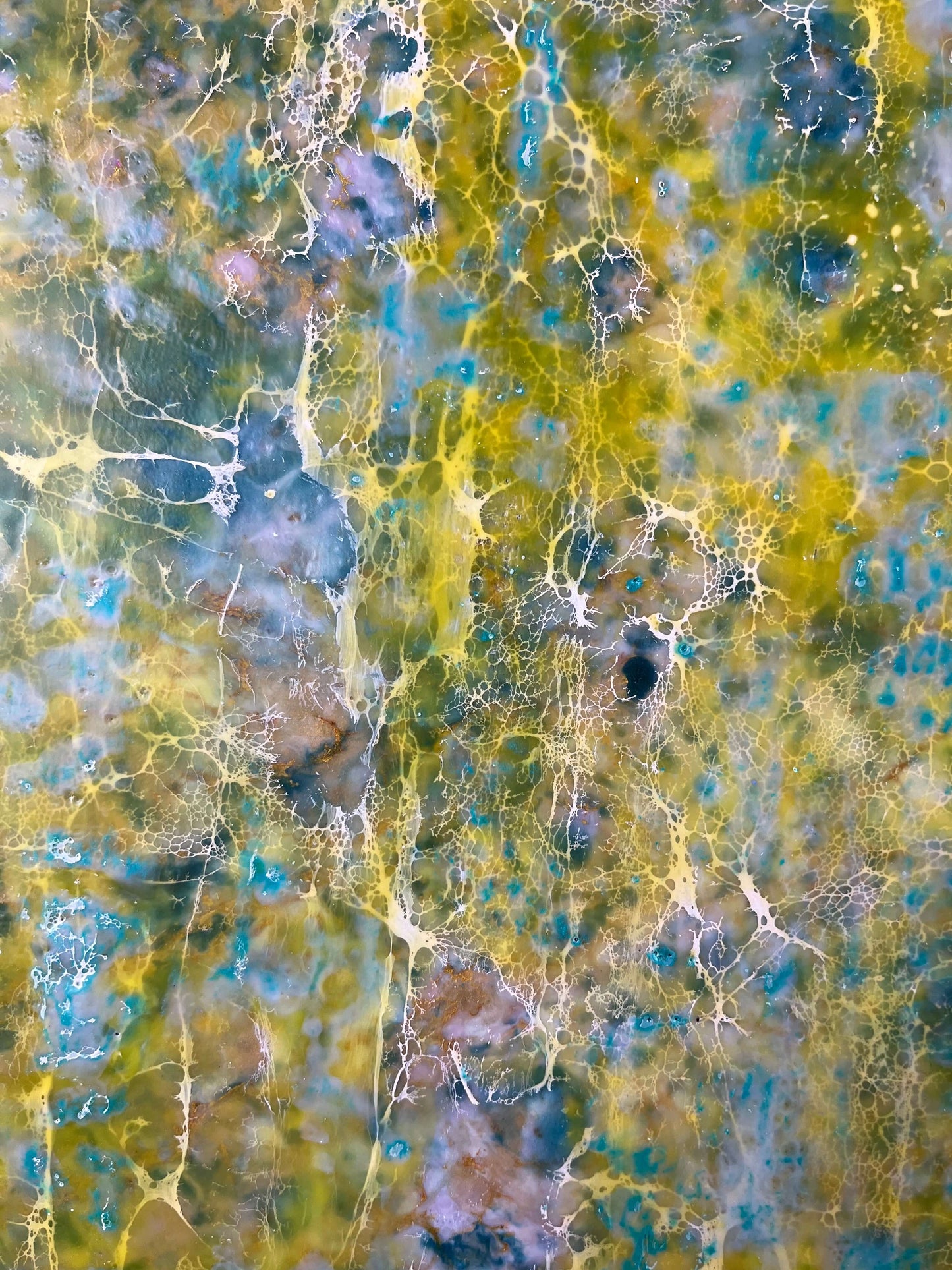 Close up.This abstract painting is reminiscent to me of a wall of an old building that has been weathered with humidity and sun. The greens and yellows are like moss that has developed on the plaster where blue paint has cracked and been peeling.