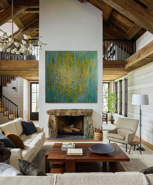 Original abstract encaustic painting in greens, yellows and blues with vertical textured layers displayed above a fireplace in a modern farmhouse interior