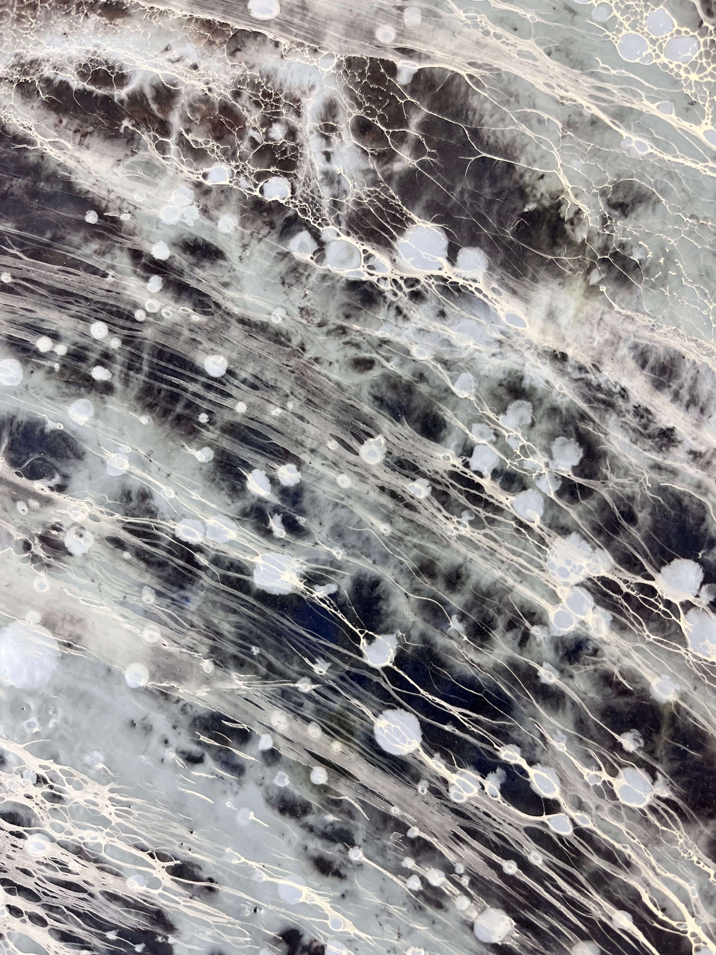 Close-up of a textured surface with black, white, and gray patterns