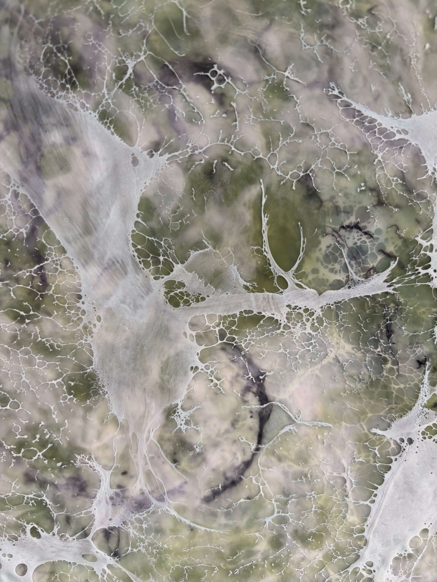 Close up, abstract painting in muted greens, grays and whites, with layered fog-like textures and webbed veils that create the impression of shifting forms within a dense mist.