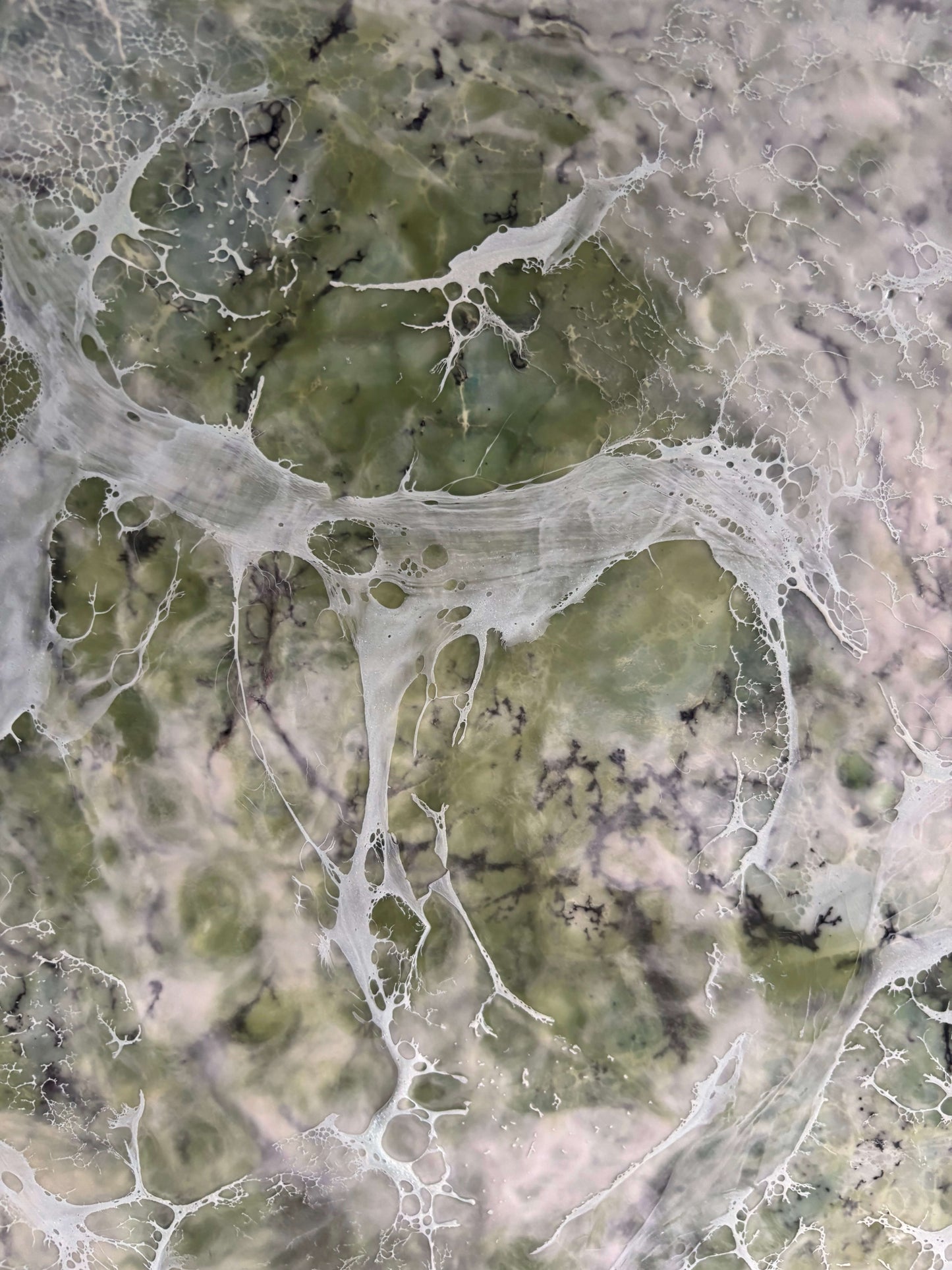 Close up, abstract painting in muted greens, grays and whites, with layered fog-like textures and webbed veils that create the impression of shifting forms within a dense mist.