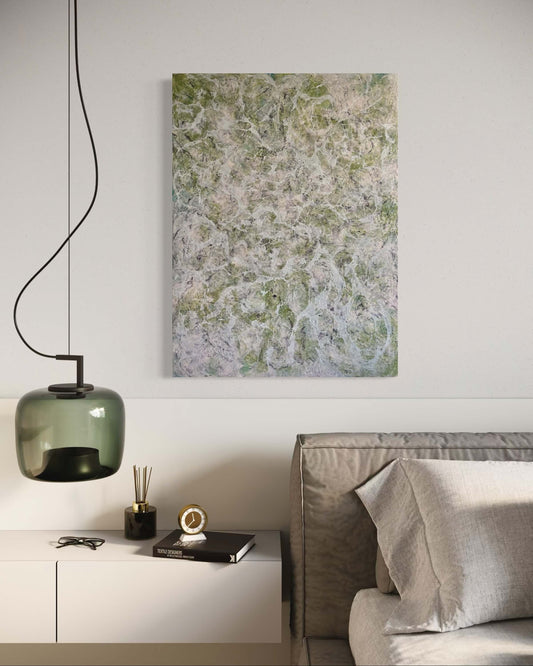 Original abstract encaustic painting in muted greens, greys and whites, with layered fog-like textures and webbed veils that create the impression of shifting forms within a dense mist displayed above a bed and lamp