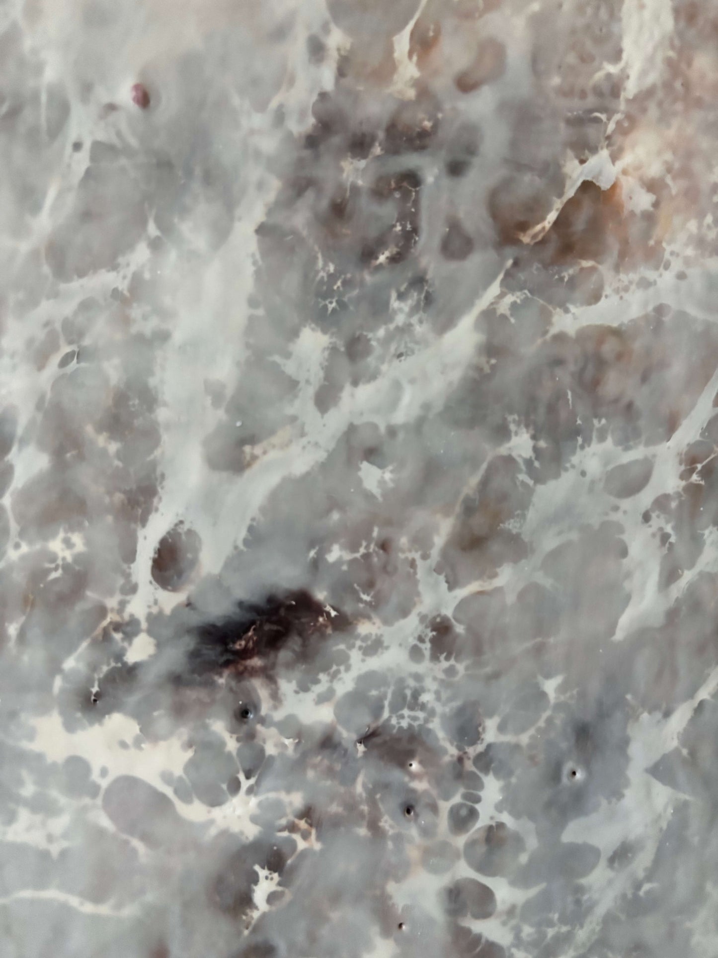 Close up.Abstract painting featuring soft, layered textures in pale neutral tones of white, beige, and hints of brown. Translucent, web-like veining spreads across the surface, creating a sense of mist, depth, and organic movement reminiscent of fog or frost.