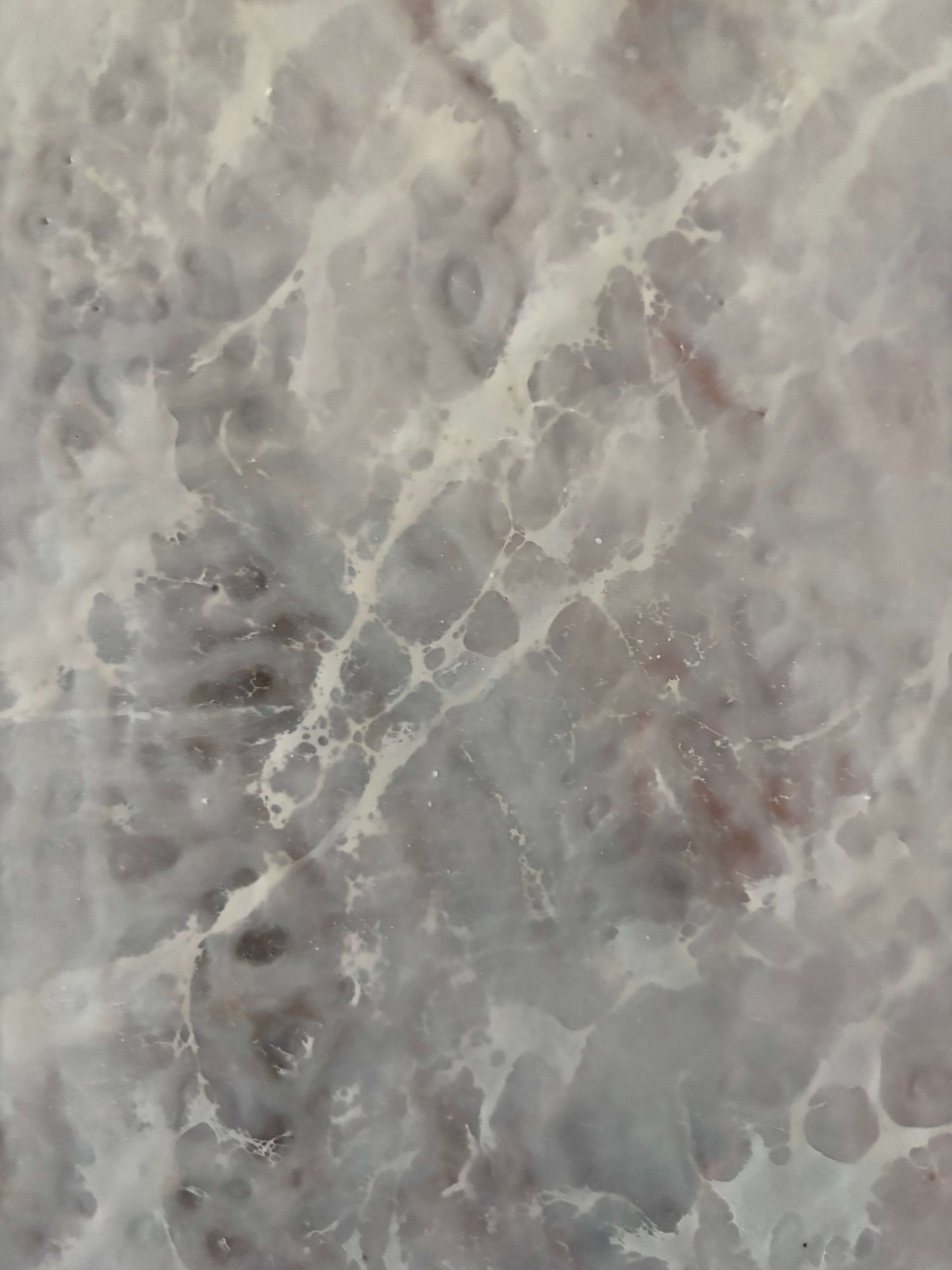 Close up.Abstract painting featuring soft, layered textures in pale neutral tones of white, beige, and hints of brown. Translucent, web-like veining spreads across the surface, creating a sense of mist, depth, and organic movement reminiscent of fog or frost.