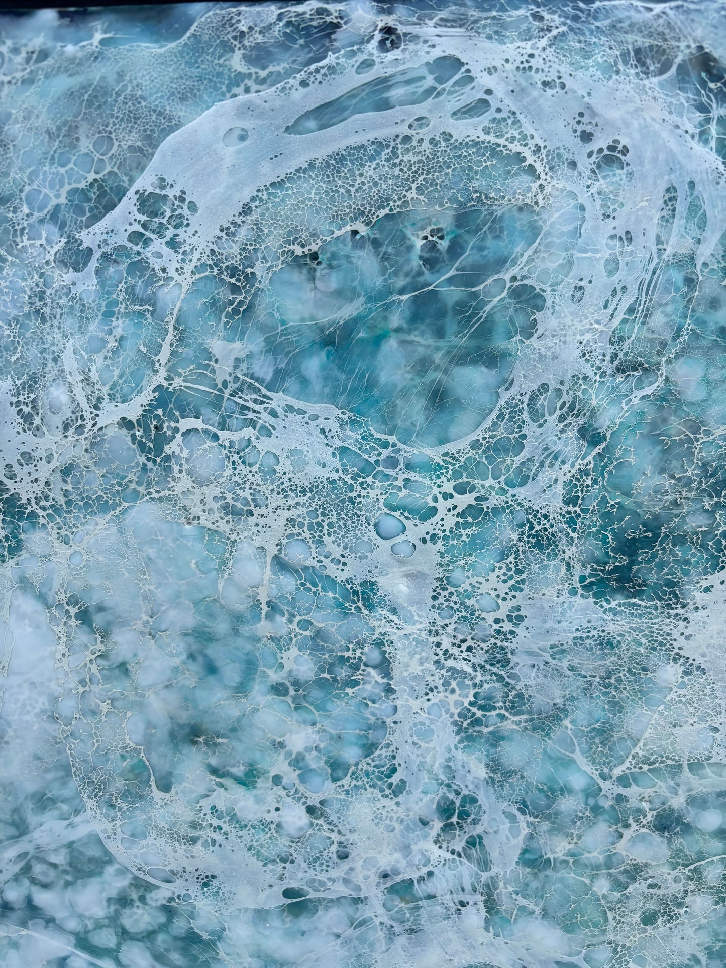Close up.Abstract painting, created with watery blues, and whites. Lace-like swirls imitating ether a crystal clear sea or sky.