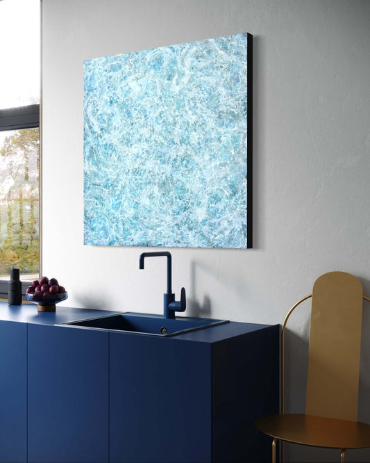 Original abstract encaustic painting, created with watery blues, and whites. Lace-like swirls imitating ether a crystal clear sea or sky displayed in modern kitchen above a blue counter