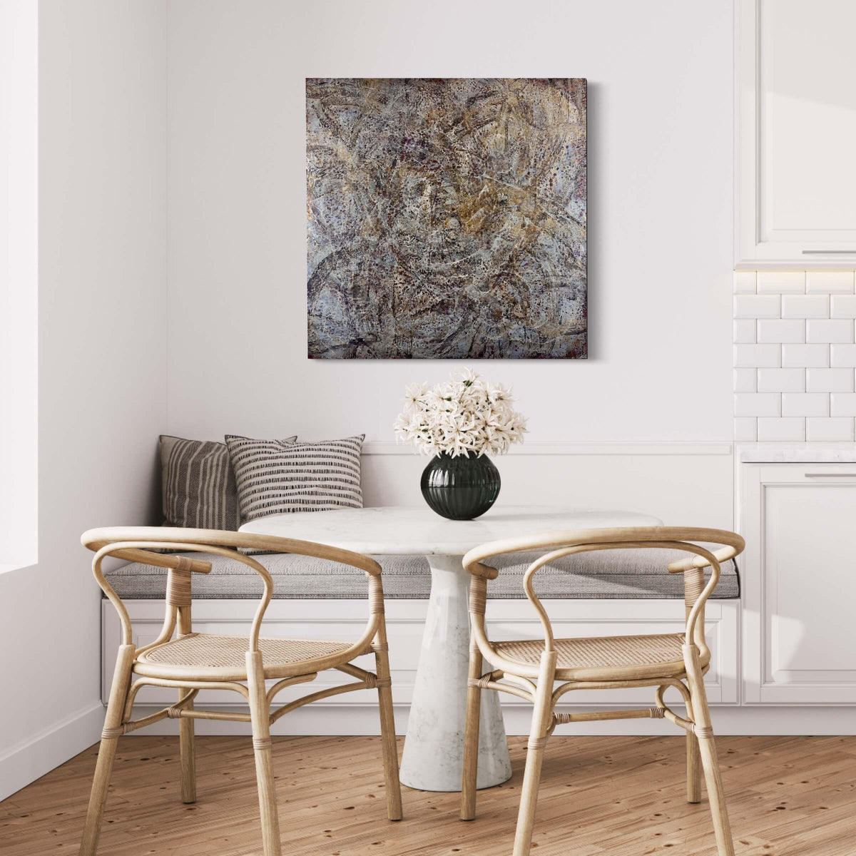 Original abstract encaustic painting in warm grey, brown, burgundy and gold with layered web-like textures in white displayed above a banquette bench in a breakfast nook