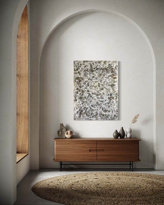 Original abstract encaustic painting in earthy browns and white, with layered weblike textures. Displayed above a credenza in a foyer