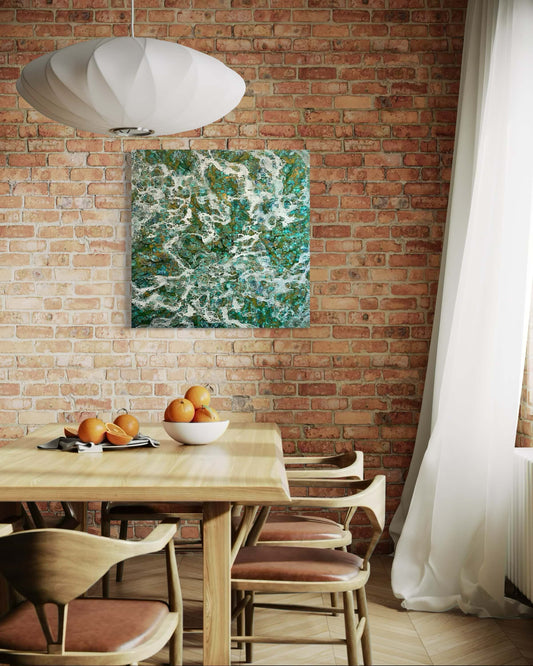 Original abstract encaustic painting with flowing white patterns over a rich mix of turquoise, emerald, and earthy tones, resembling ocean foam or mineral formation displayed on a red brick wall in a modern dining room interior