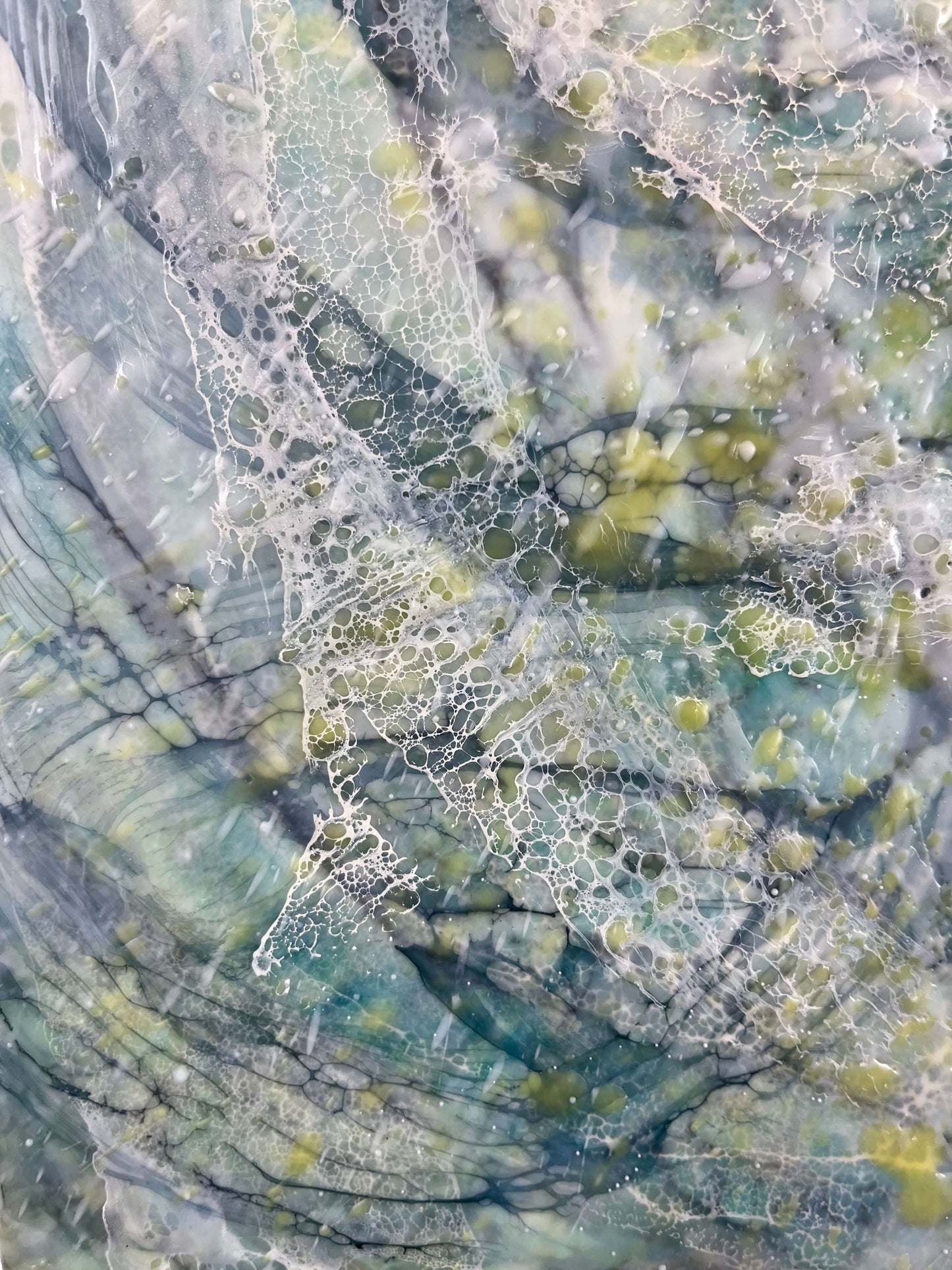 close up.16x20in. This abstract painting was named and inspired by a song written by Damien Jurado, Working Titles. This piece of music, even though the overall sound is melodic and very calming, the lyrics, however are about heartbreak. The overall feel of this painting is quite serene with its blues, greens and yellows. The colours are reminiscent of evergreens of Seattle WA shrouded in dense fog. The delicate lace like texture created by shellac has an interesting flowing pattern.