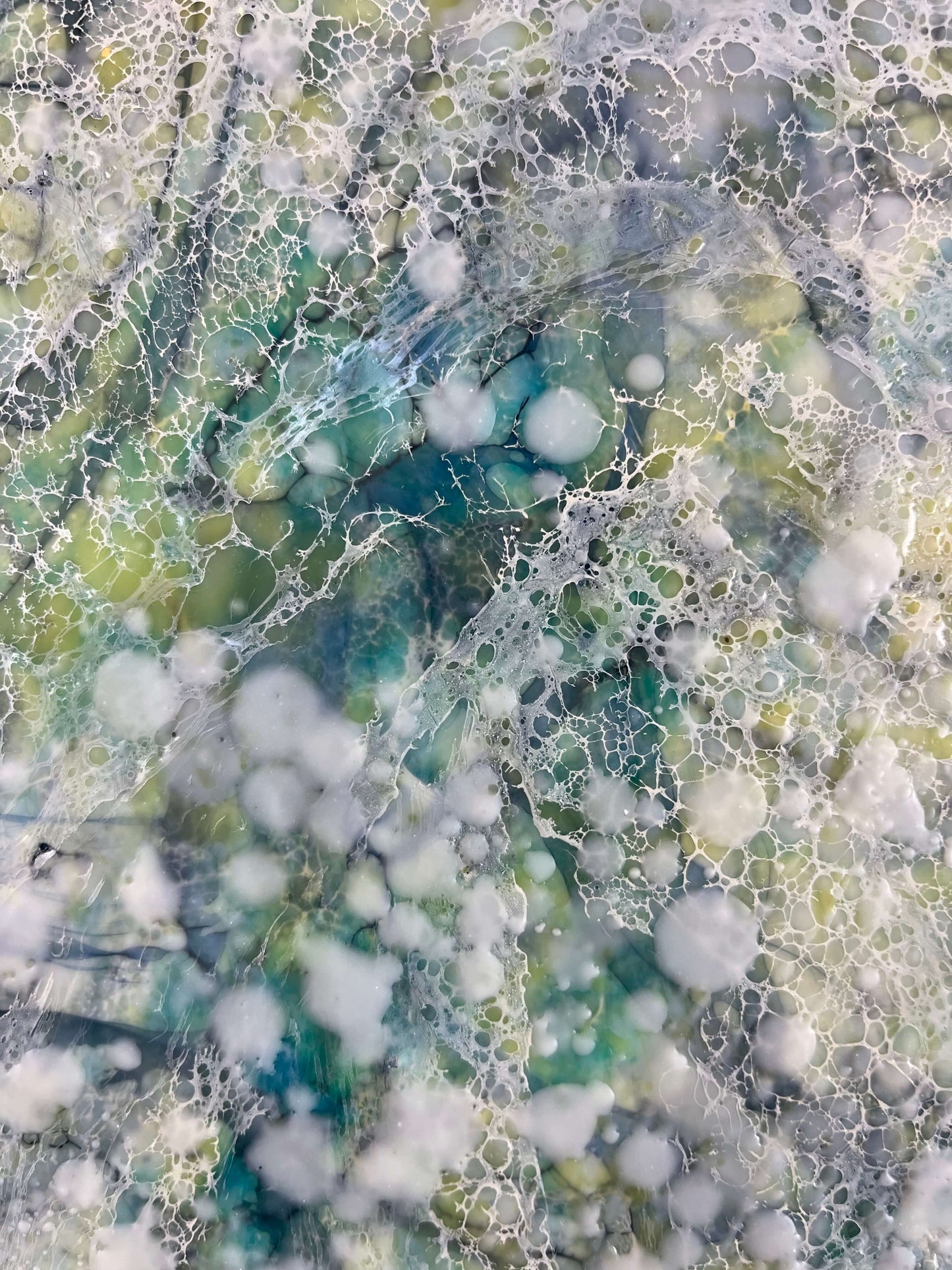 close up.16x20in. This abstract painting was named and inspired by a song written by Damien Jurado, Working Tittles. This piece of music, even though the overall sound is melodic and very calming, the lyrics, however are about heartbreak. The overall feel of this painting is quite serene with its blues, greens and yellows. The colours are reminiscent of evergreens of Seattle WA shrouded in dense fog. The delicate lace like texture created by shellac has an interesting flowing pattern.