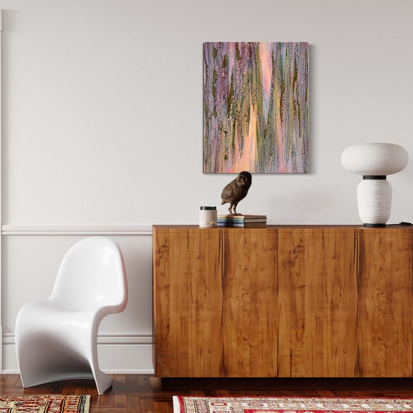 In situ.Abstract Encaustic Painting, 16x20in. Created with beeswax, damar resin, dry pigments and shellac on cradled wood panel. This painting is playful, but delicate with a gentle energy. The colours of this piece are soft pinks, periwinkle blues, majestic purples and moody greens. The delicate lace-like texture draping over the painting has this protective and enveloping effect as if the colours underneath it, while blending with each other, are shy and private. Hanging hardware is included