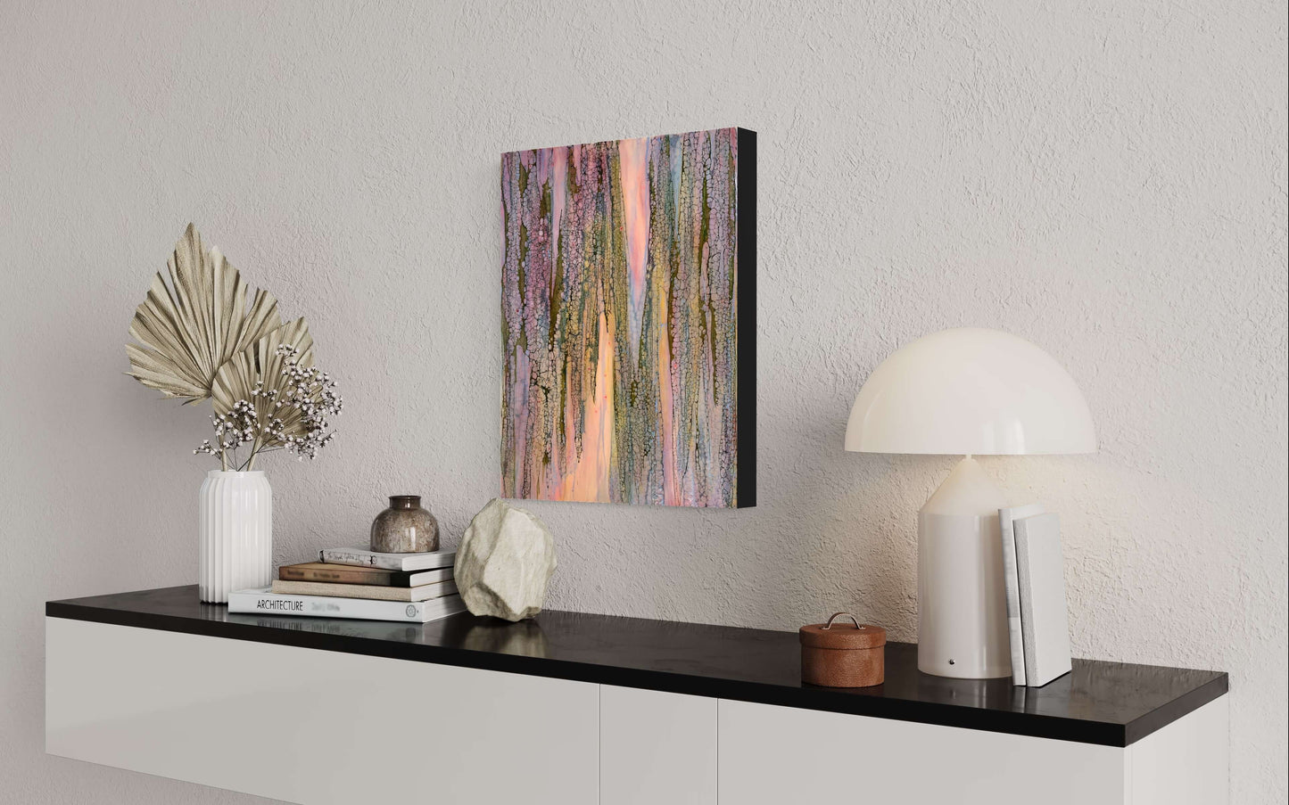 In situ.Abstract Encaustic Painting, 16x20in. Created with beeswax, damar resin, dry pigments and shellac on cradled wood panel. This painting is playful, but delicate with a gentle energy. The colours of this piece are soft pinks, periwinkle blues, majestic purples and moody greens. The delicate lace-like texture draping over the painting has this protective and enveloping effect as if the colours underneath it, while blending with each other, are shy and private. Hanging hardware is included