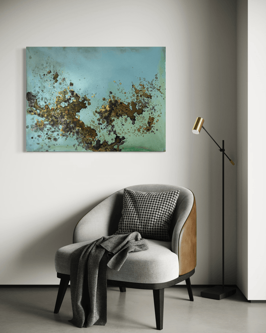 Original abstract painting in blue, green, brown with rust and gold layered textures and organic forms displayed above an armchair and floor lamp in modern interior