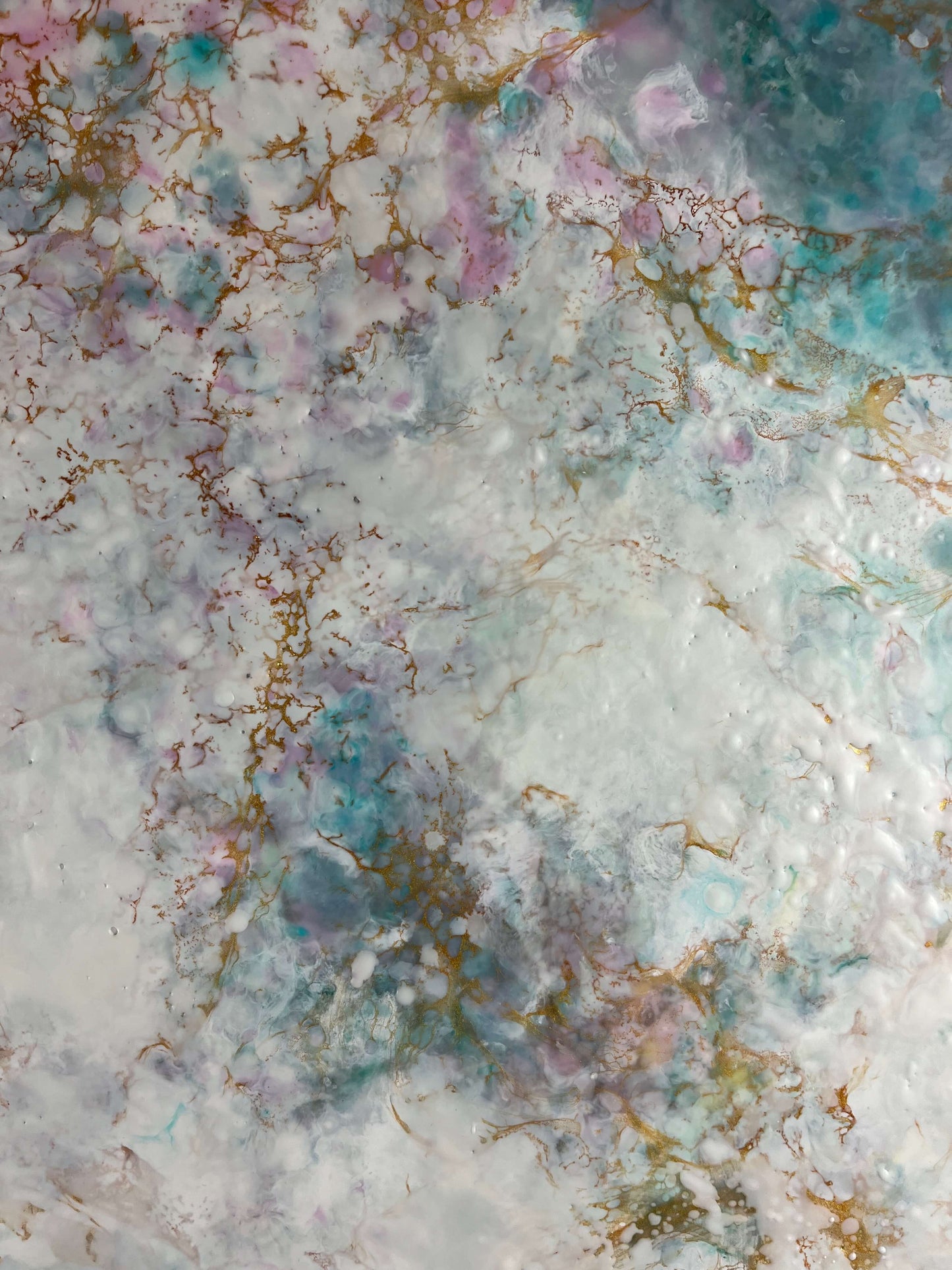 Close up. This piece has a calming feel to it with blue greens, white, pinks and gold. it creates an ethereal feeling with the what looks like a magical cloud floating by.