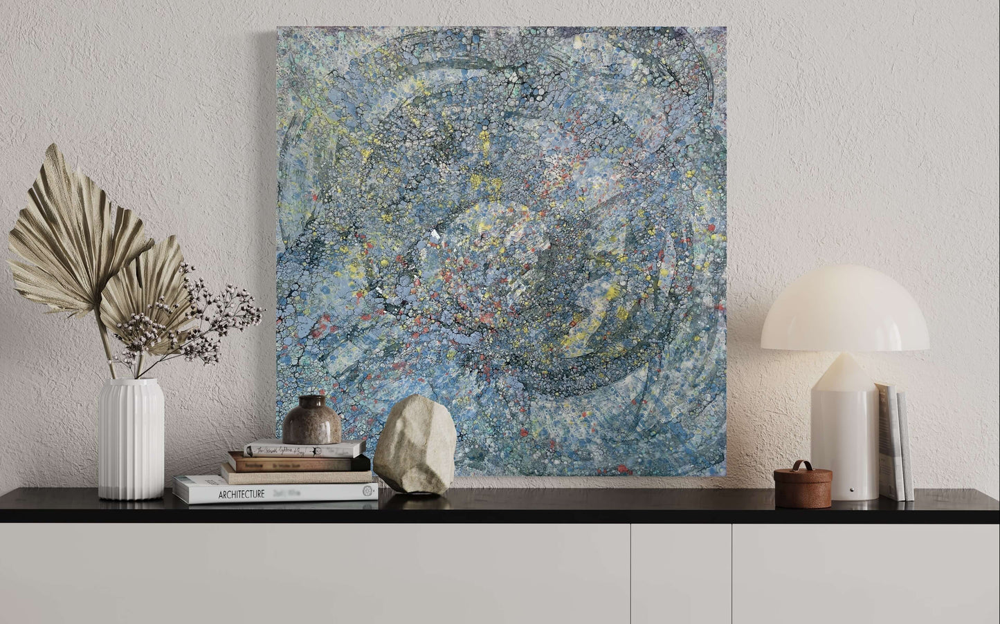 In situ.This piece has a very uplifting energy with its variations of blues, greys and specks of yellow and orange. it is a textured painting, when you run your fingers over it, you will feel ripples of wax. The droplets of orange wax signifies Monarch butterflies taking to the sky.