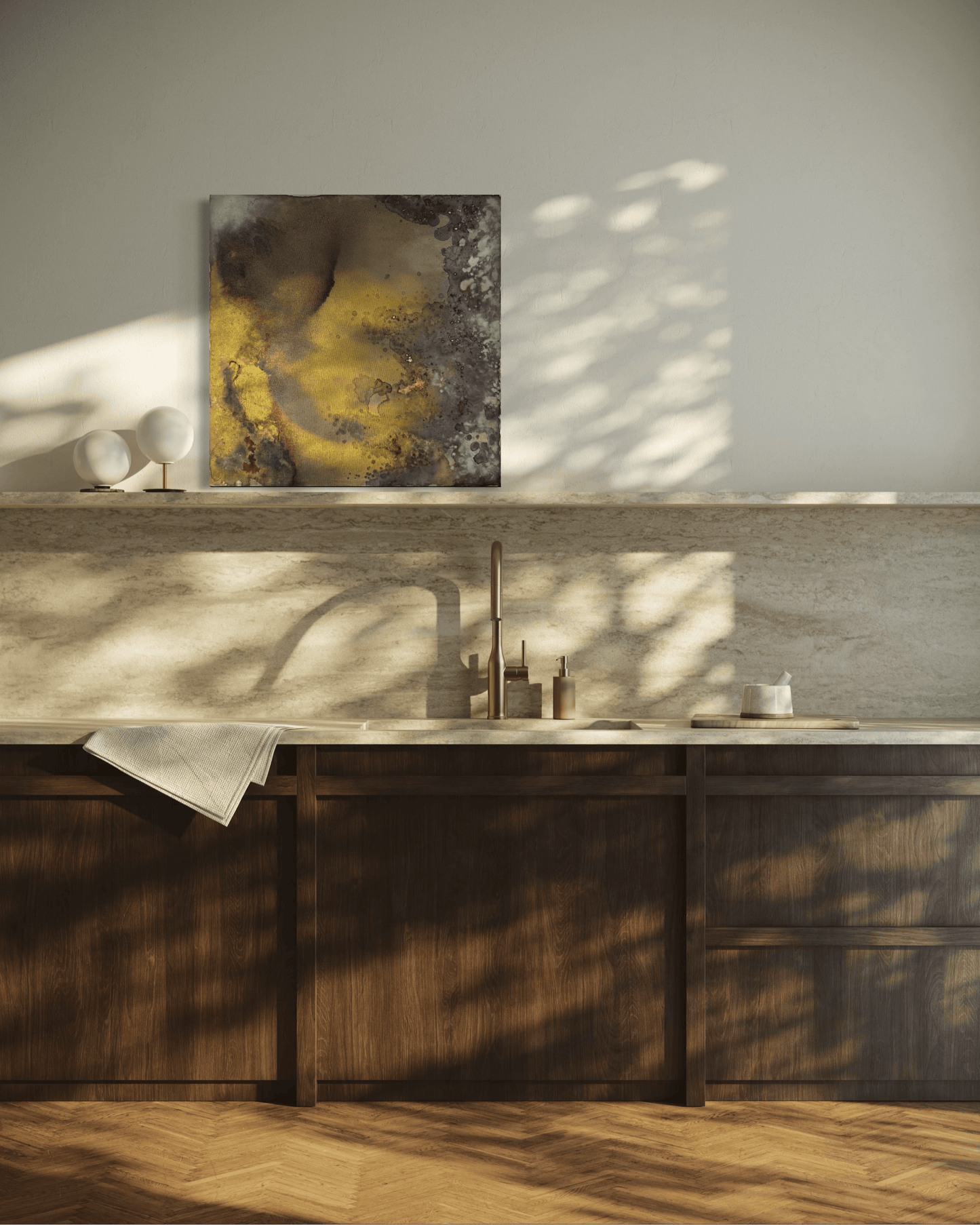 Original abstract painting with brown, rust, gold and grey tones with layered textures and organic forms displayed on a stone backsplash shelf  in modern kitchen interior