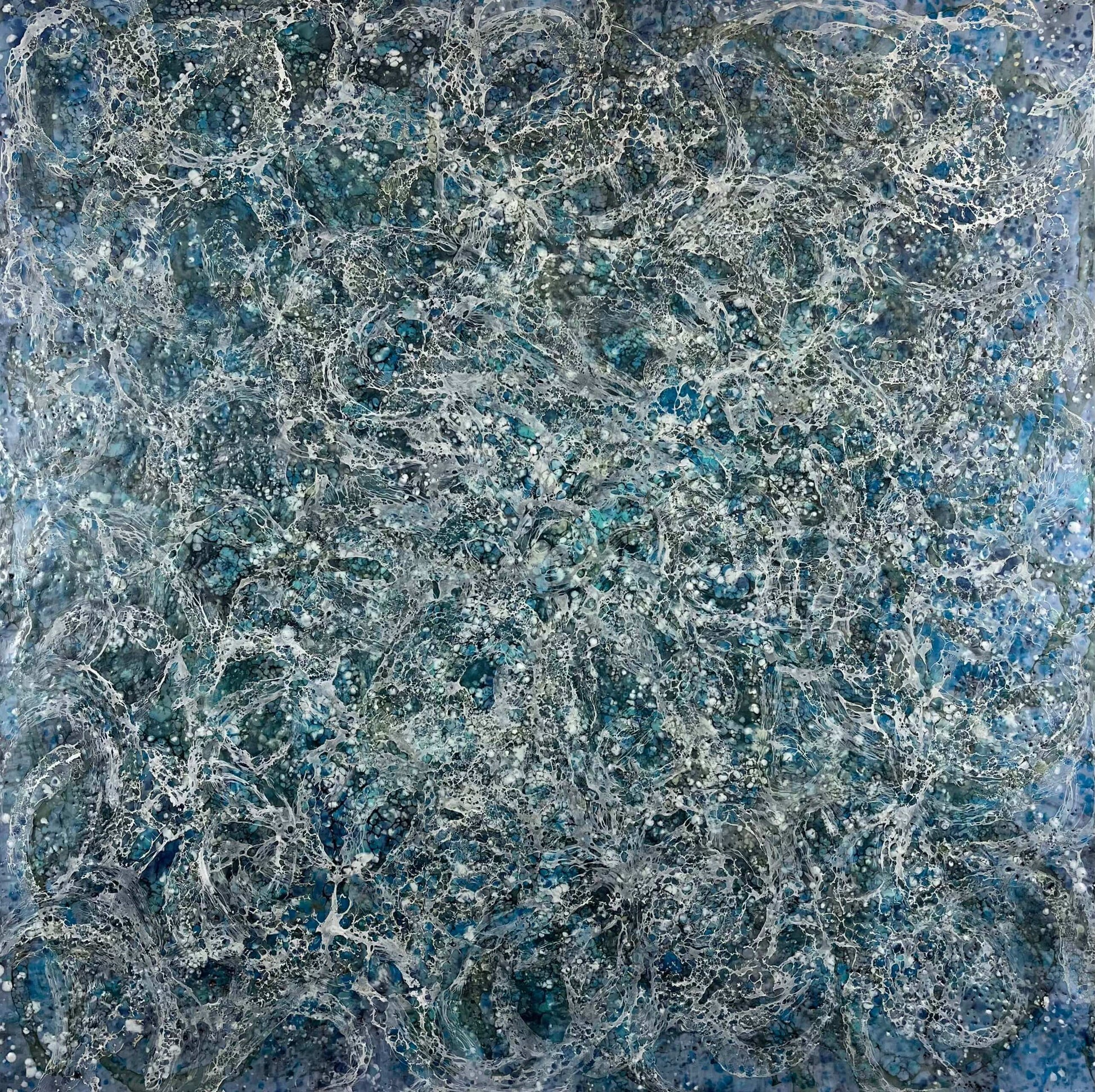 Encaustic painting in blue and white tones with lots of visual texture and many lace-like swirls. Square panel 40x40inches. It is an abstract painting, and it resembles foaming ocean waters as they hit the rocks.