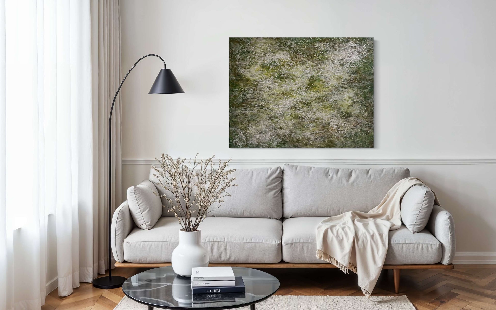 Abstract painting with delicate layers of soft white, mossy green and earthy tones. The surface is textured with fine, mist like dots, and organic forms, evoking a sense of gentle movement, growth, and natural stillness. Displayed in modern space
