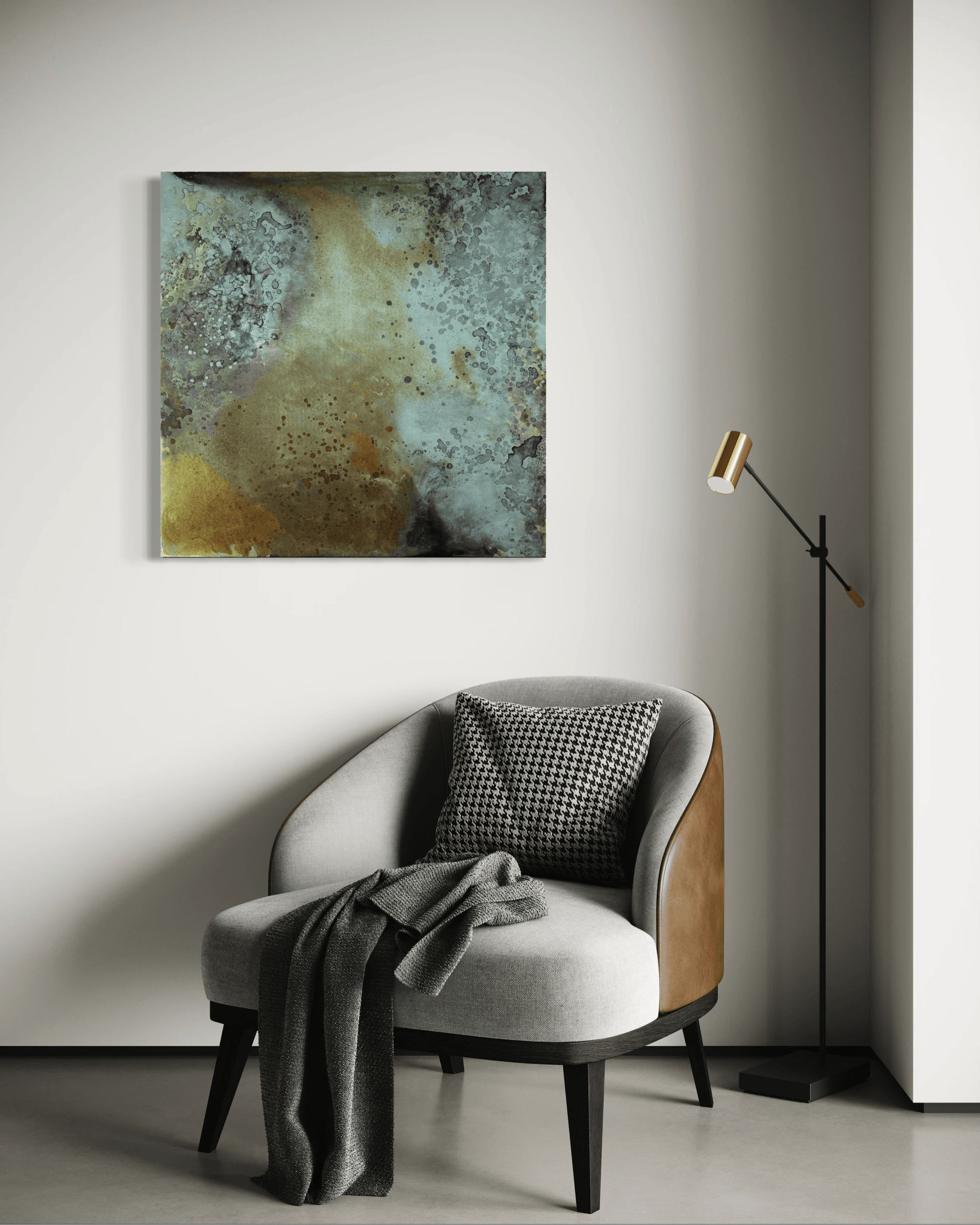 Original abstract painting in blue, grey, brown and gold tones with layered textures and organic forms displayed above  an armchair and a floor lamp in a modern interior.