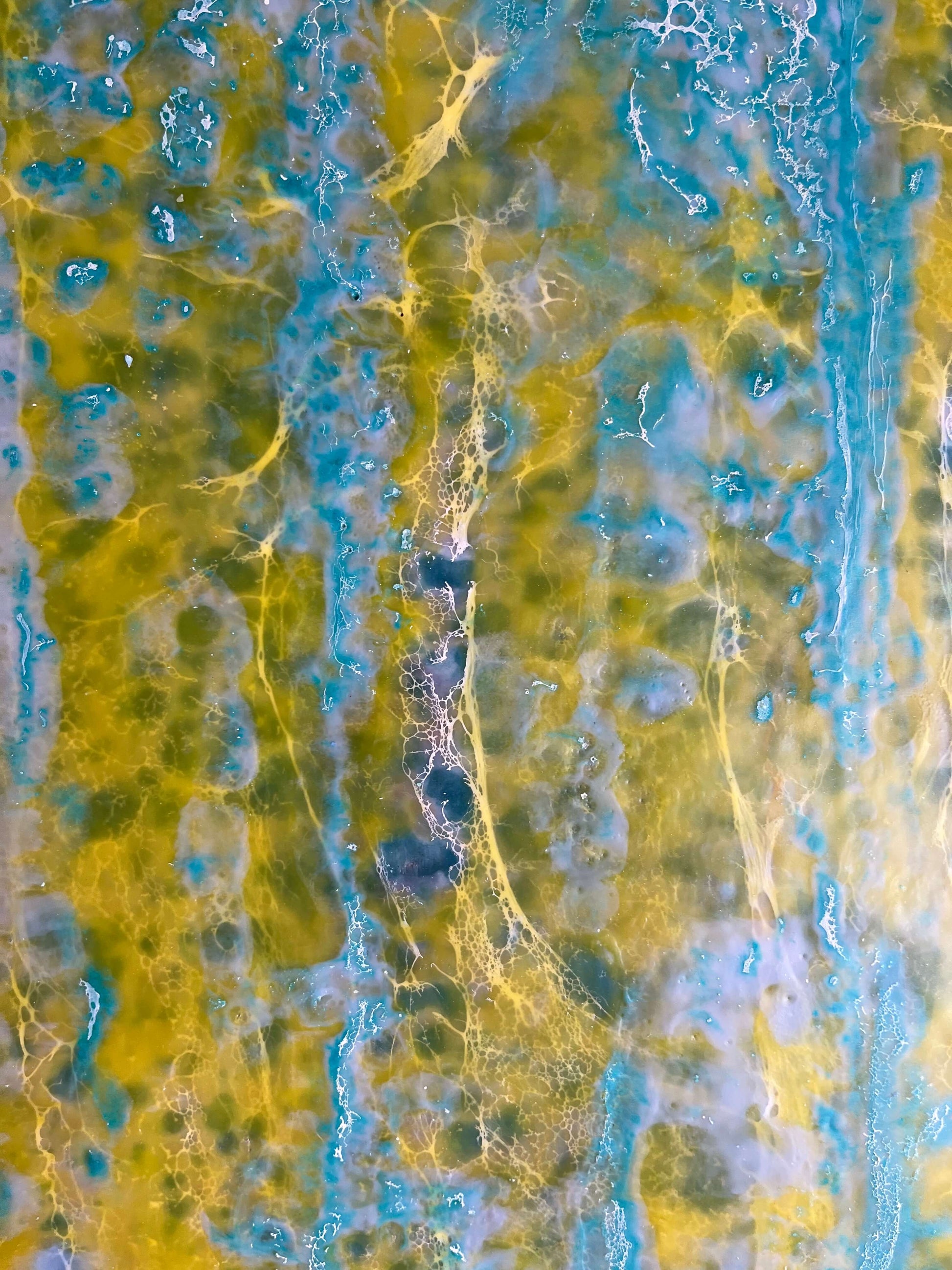 Close up.This painting is reminiscent to me of a wall of an old building that has been weathered with humidity and sun. The greens and yellows are like moss that has developed on the plaster where blue paint has cracked and been peeling.