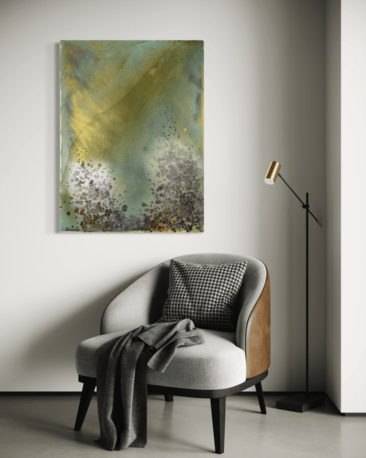 Original abstract painting in yellow, green, blue, gold with layered wine stain textures and organic forms displayed above an armchair and floor lamp in modern interior