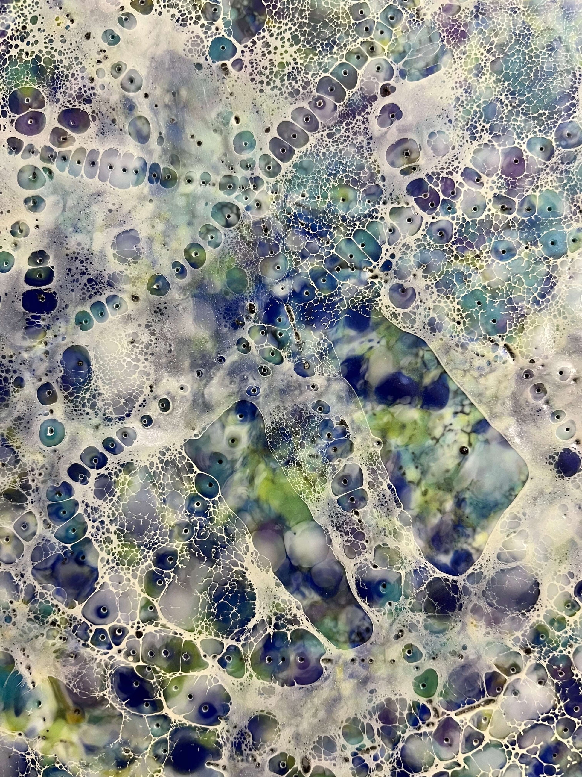 Close up.This painting colours are purples, blues, greens, yellow and white. The strong directional lines are created with pointillism technique using a needle. The shellac once it is burned, it created bubbles around each point resulting in a crochet type of pattern.