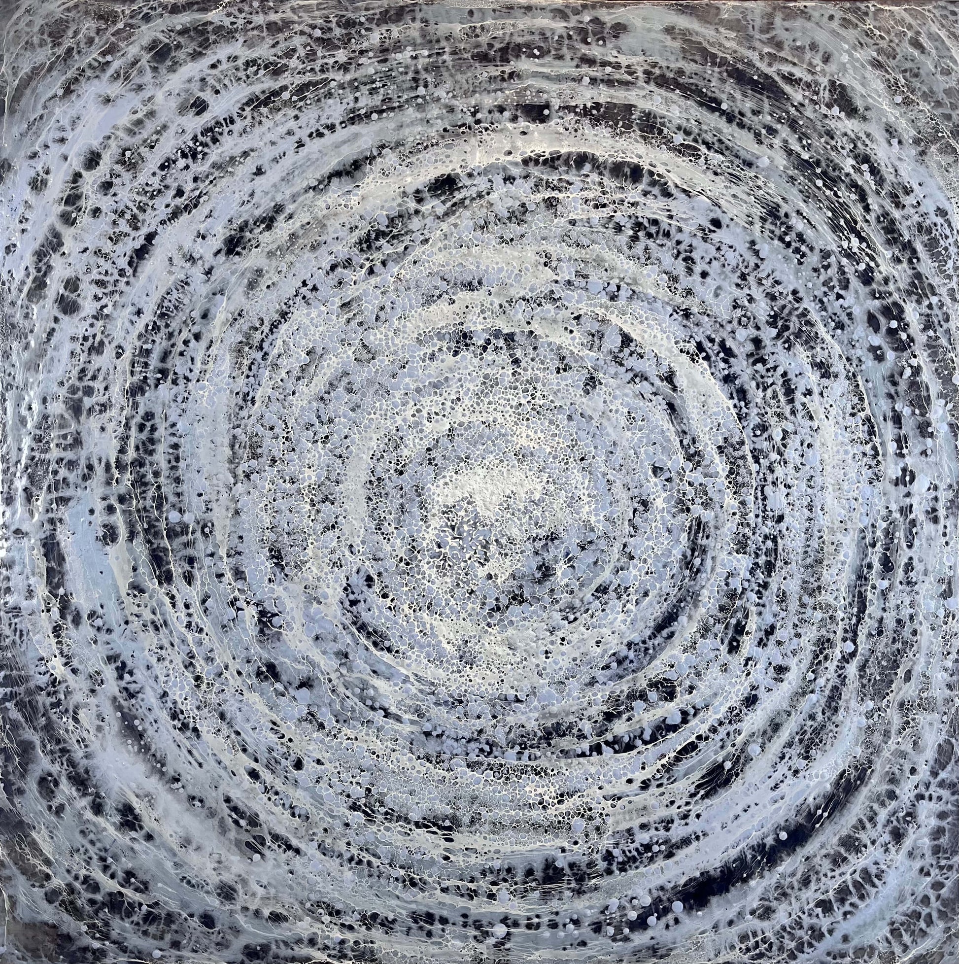 Abstract circular pattern with concentric circles in black, white and blue
