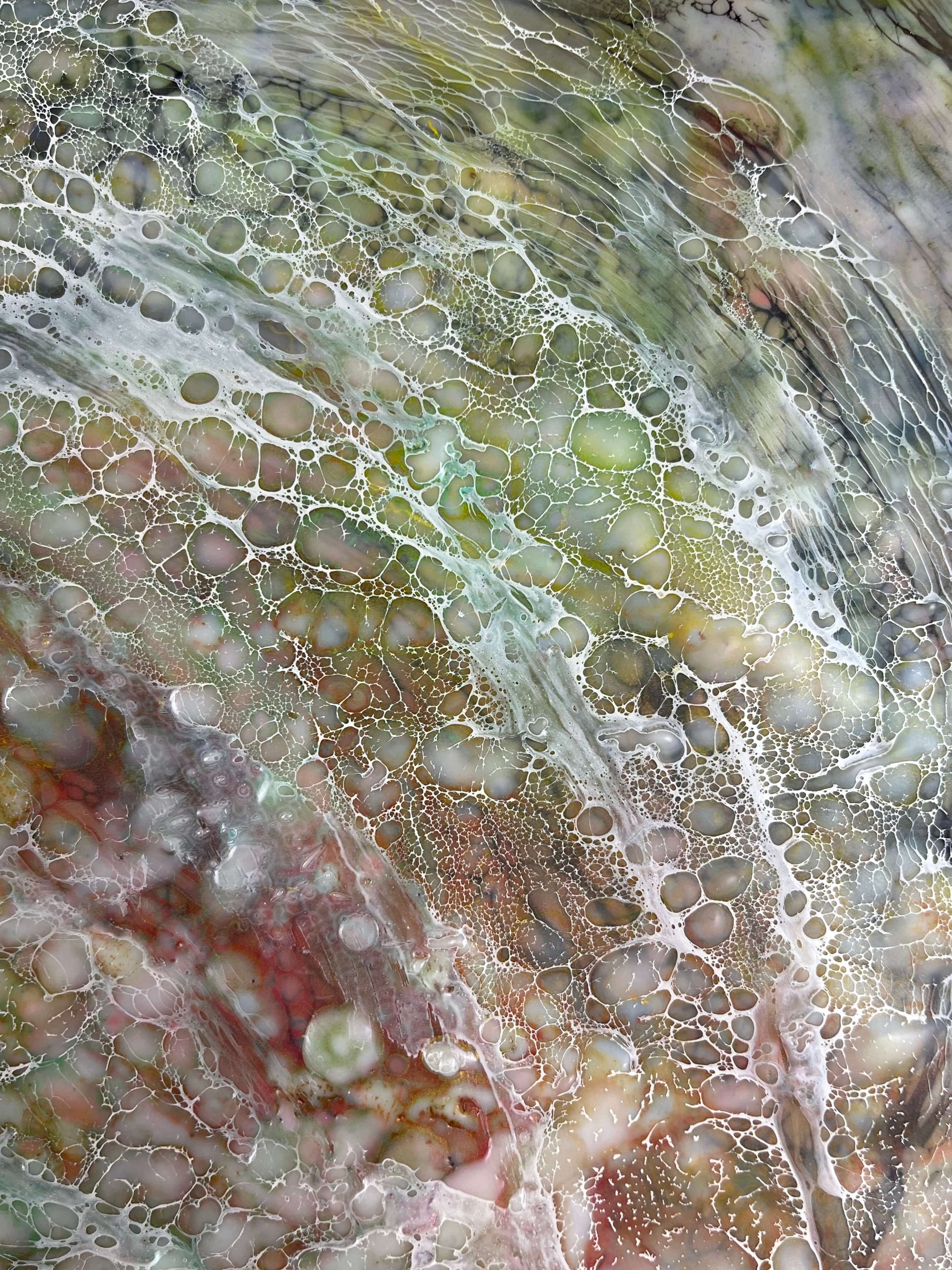 Close up.This painting has rippled texture with warm greens, orange, yellow and reds. Wispy lace-like texture of shellac creates movement within the painting.