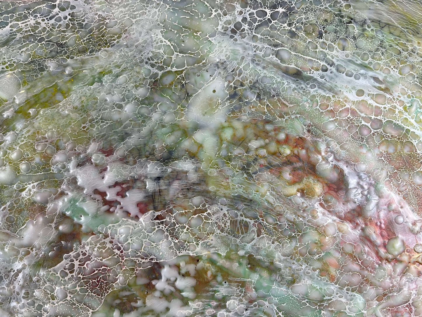 Close up.This painting has rippled texture with warm greens, orange, yellow and reds. Wispy lace-like texture of shellac creates movement within the painting.