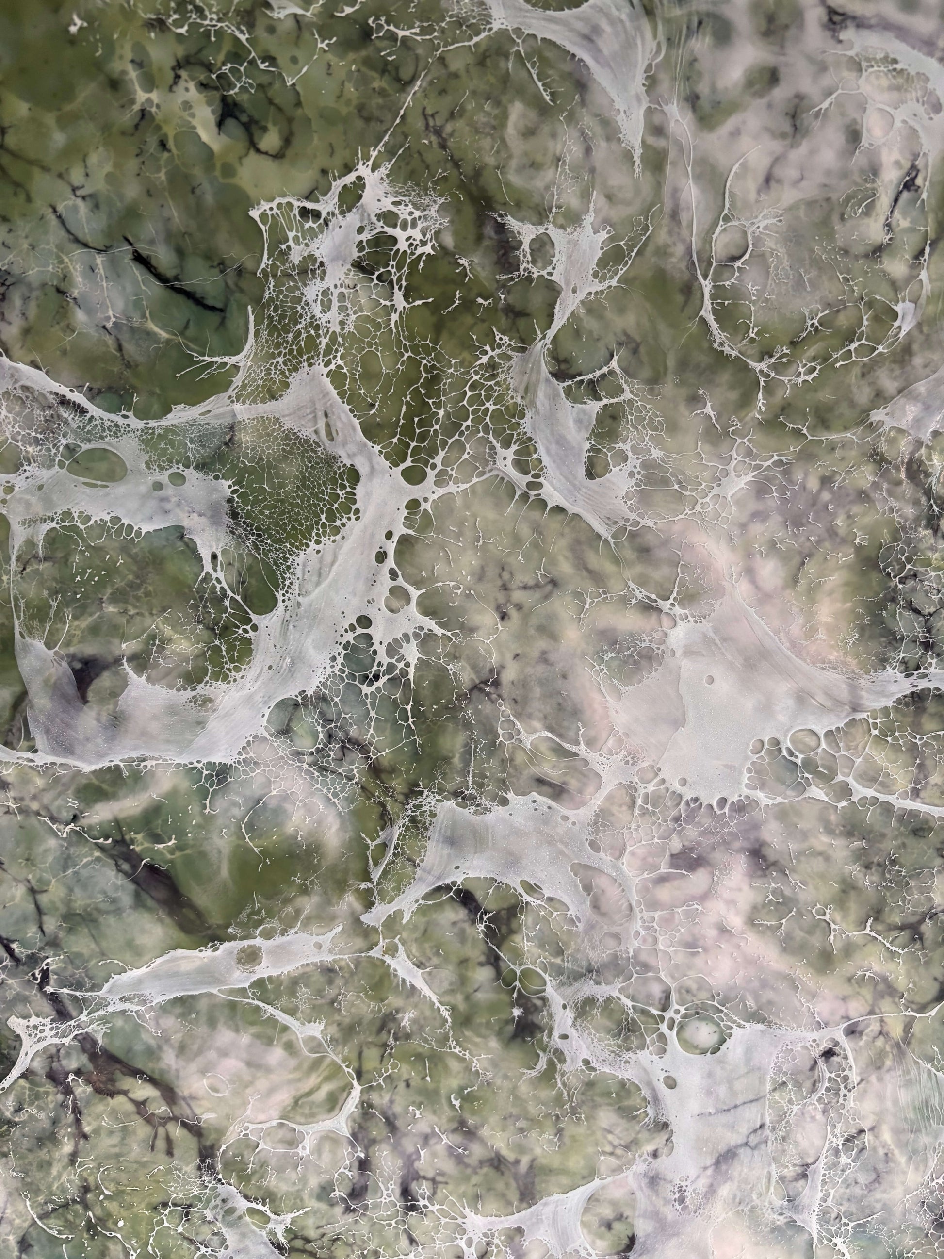 Close up, abstract painting in muted greens, grays and whites, with layered fog-like textures and webbed veils that create the impression of shifting forms within a dense mist.