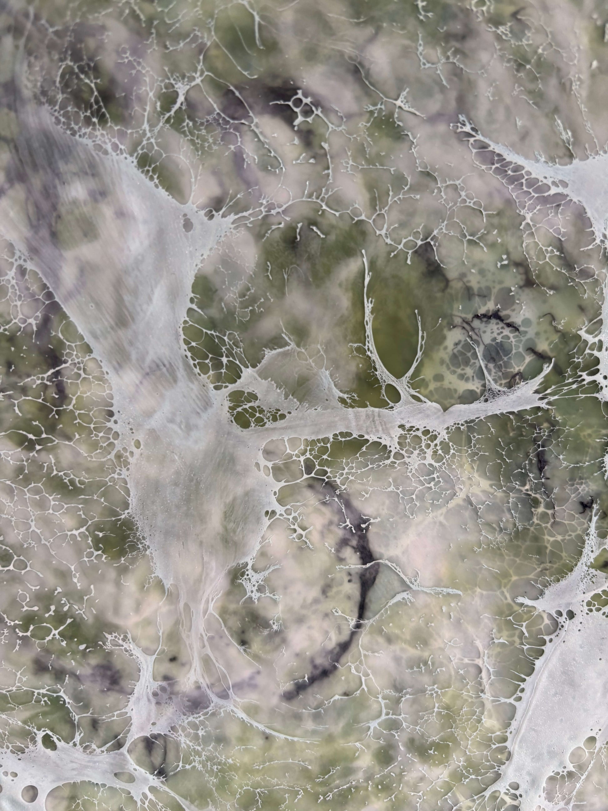 Close up, abstract painting in muted greens, grays and whites, with layered fog-like textures and webbed veils that create the impression of shifting forms within a dense mist.