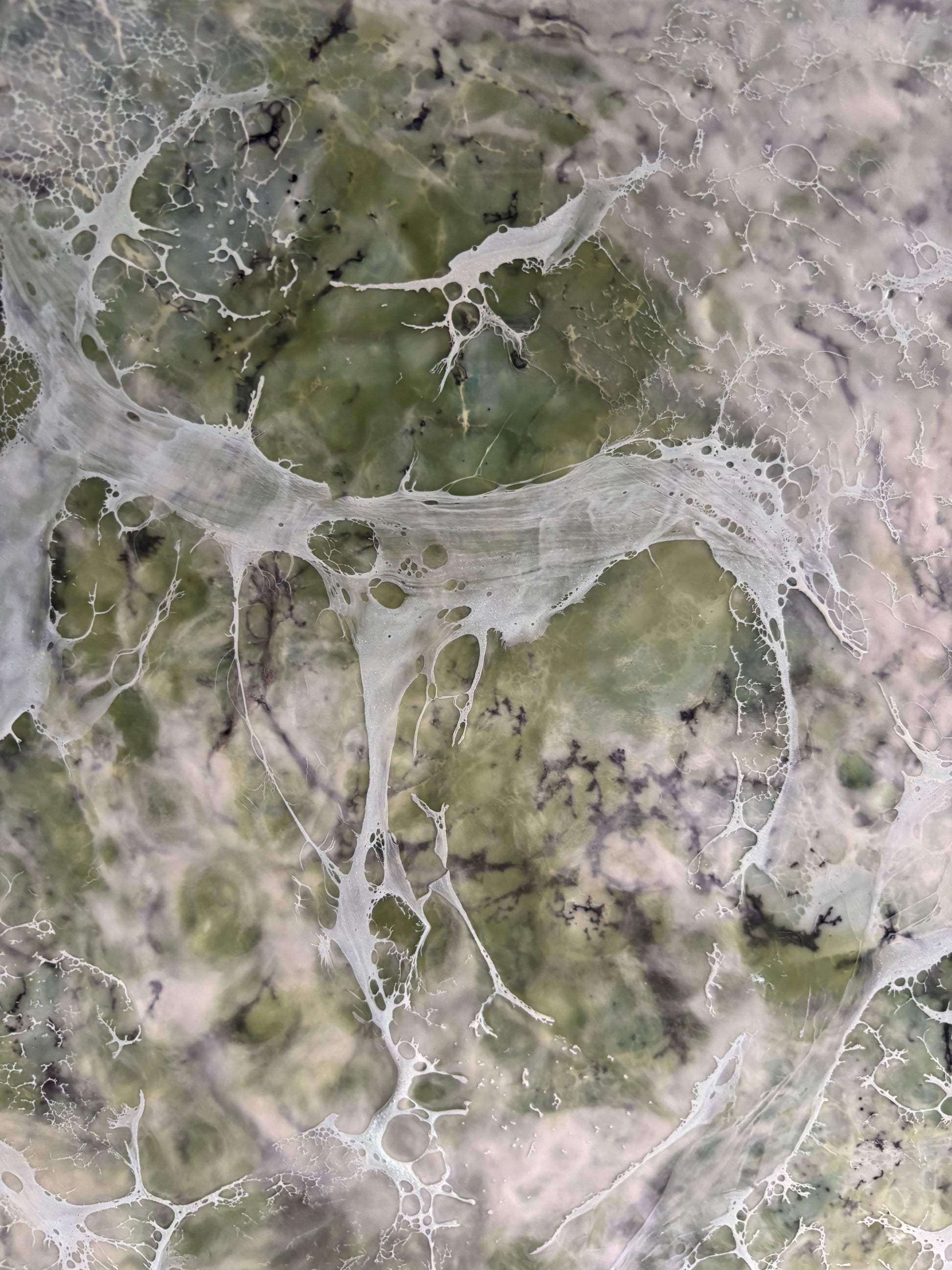 Close up, abstract painting in muted greens, grays and whites, with layered fog-like textures and webbed veils that create the impression of shifting forms within a dense mist.