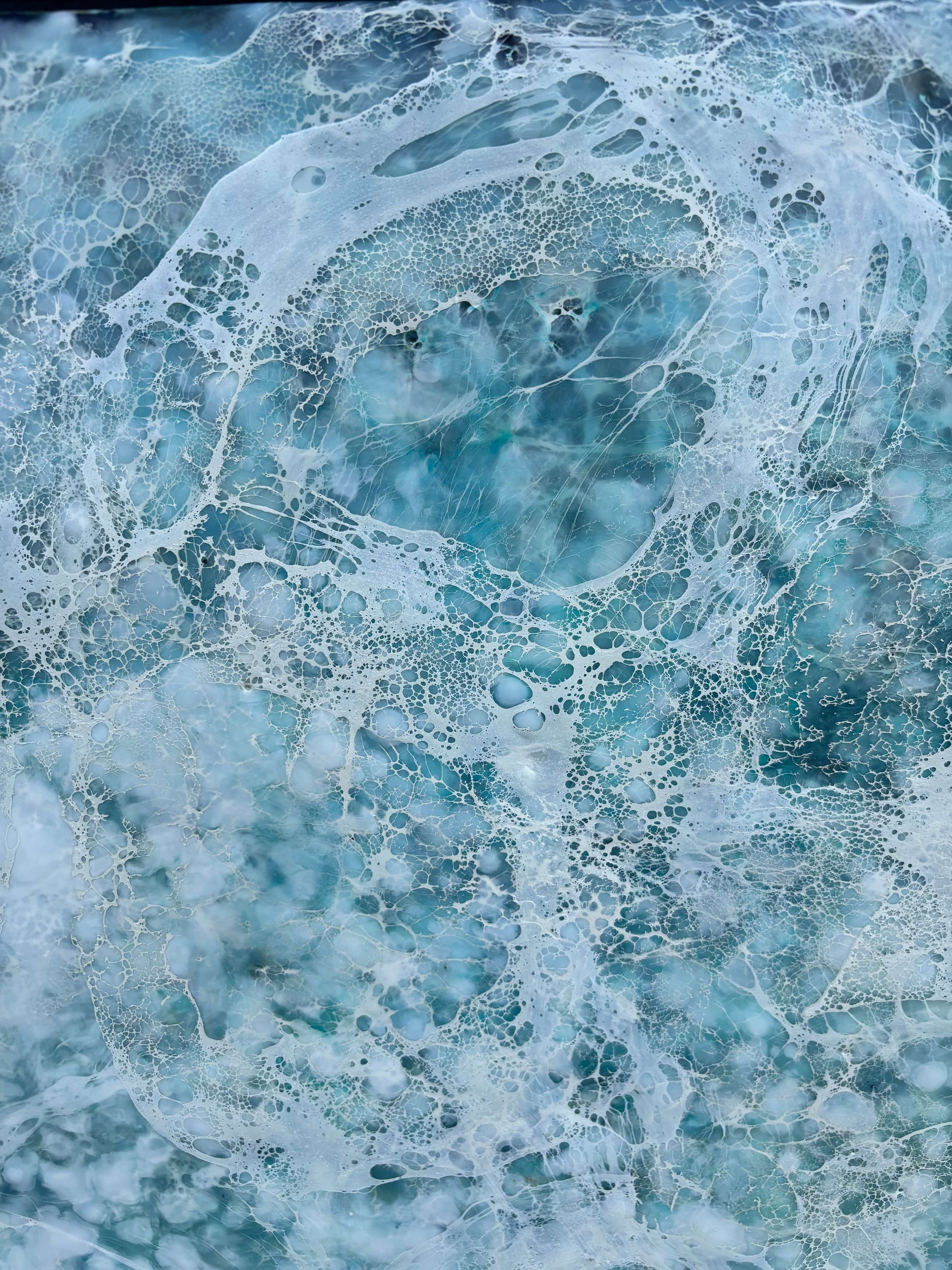 Close up.Abstract painting, created with watery blues, and whites. Lace-like swirls imitating ether a crystal clear sea or sky. 