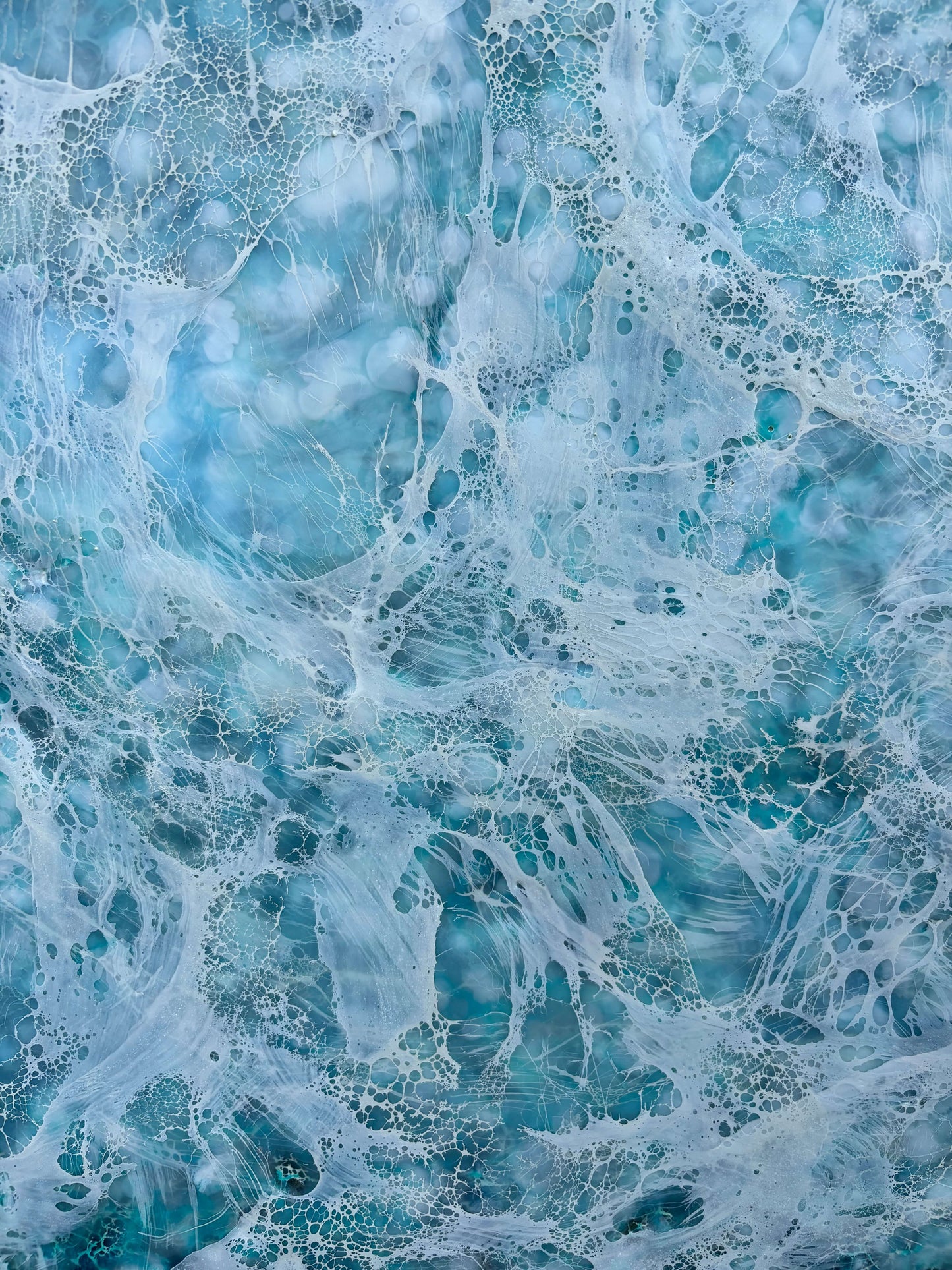 Close up.Abstract painting, created with watery blues, and whites. Lace-like swirls imitating ether a crystal clear sea or sky. 
