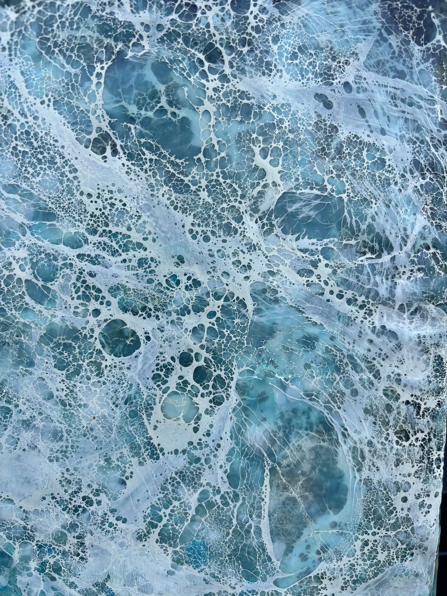 Close up.Abstract painting, created with watery blues, and whites. Lace-like swirls imitating ether a crystal clear sea or sky. 