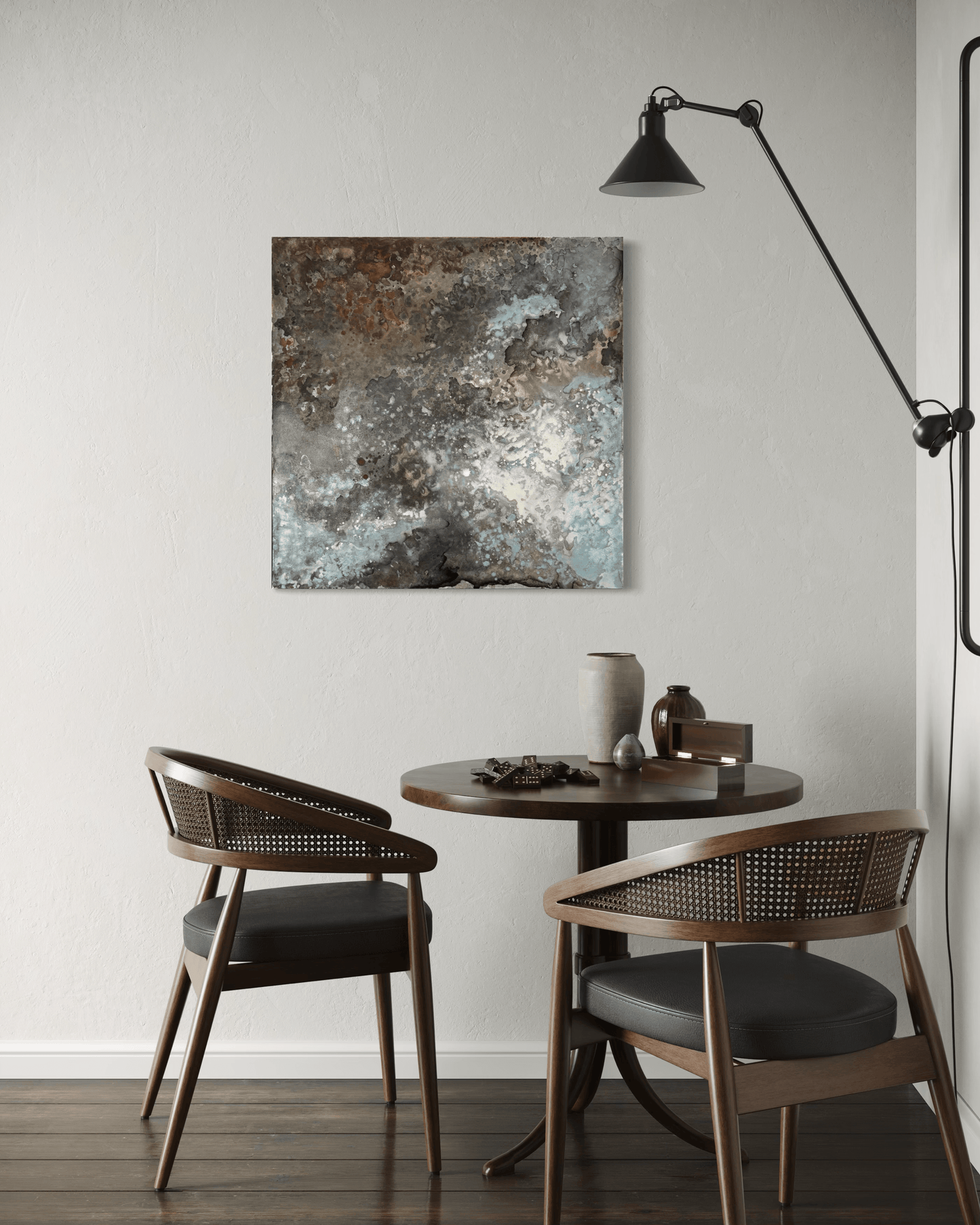 Original abstract painting with rust and corrosion pattern in blue, grey, white and silver tones with organic forms which make it seem like it is on a metal surface.
The painting is displayed on a wall in a breakfast nook in a midcentury modern interior