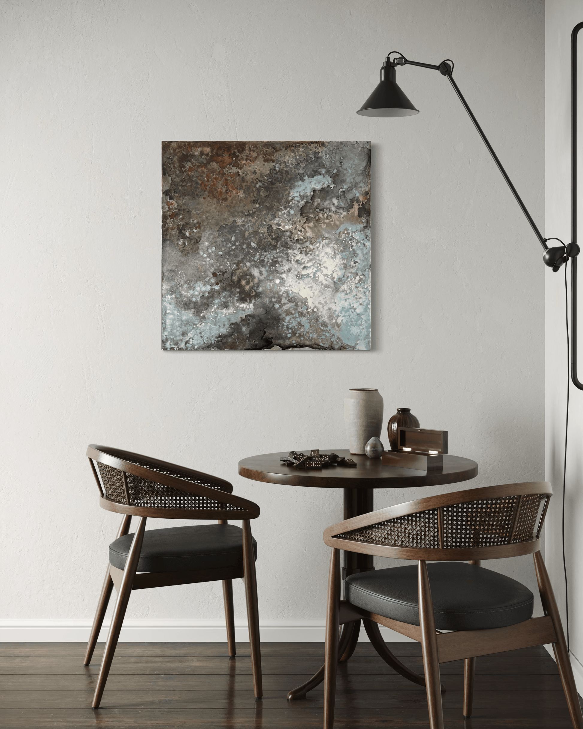 Original abstract painting with rust and corrosion pattern in blue, grey, white and silver tones with organic forms which make it seem like it is on a metal surface.
The painting is displayed on a wall in a breakfast nook in a midcentury modern interior
