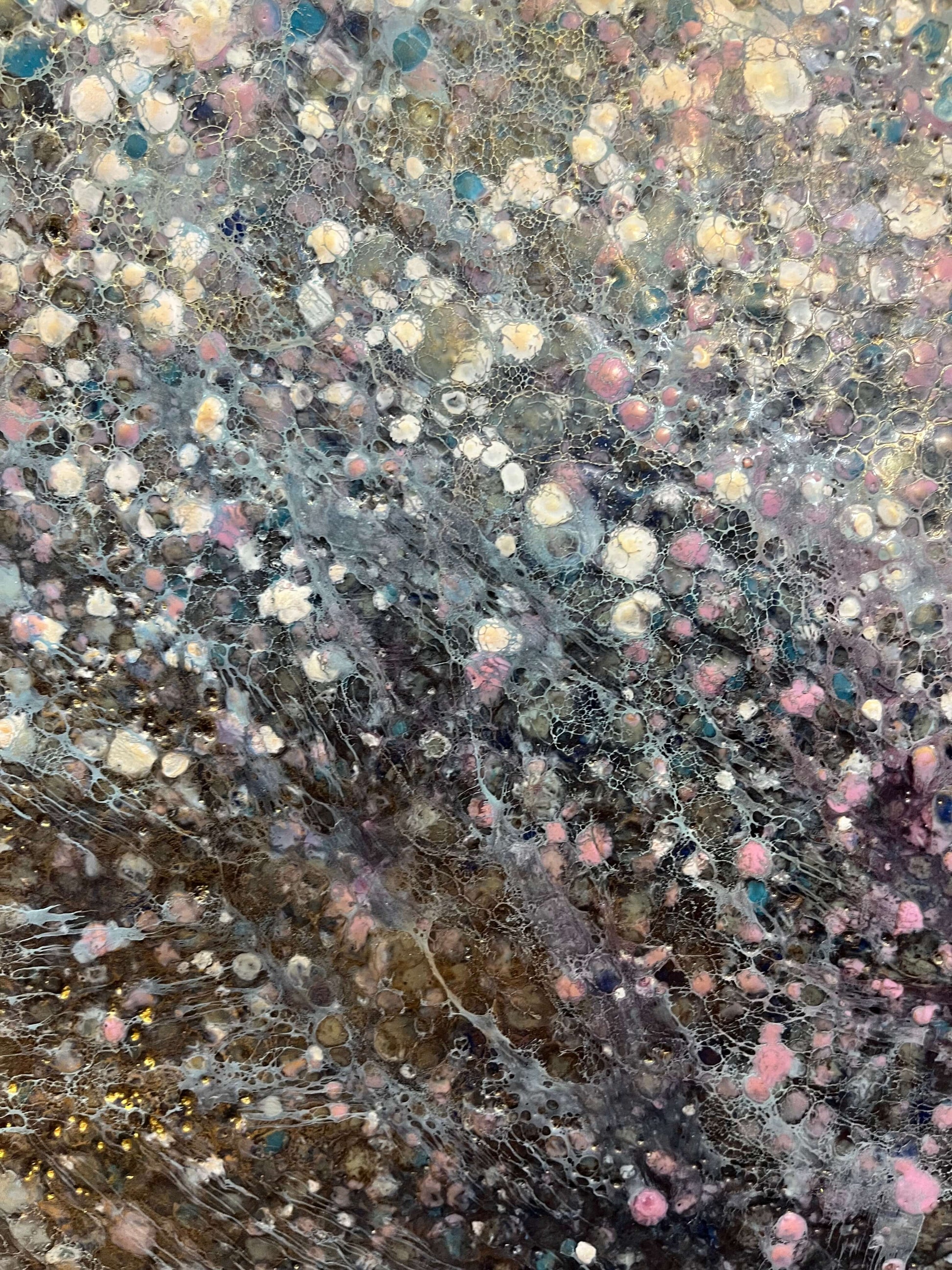 Close up.This painting has a vibrational feeling,  it resembles the glow, movement and flickering of stars and the vastness of our universe. With moody colours of black, grey, white, blues, pink and accents of gold.