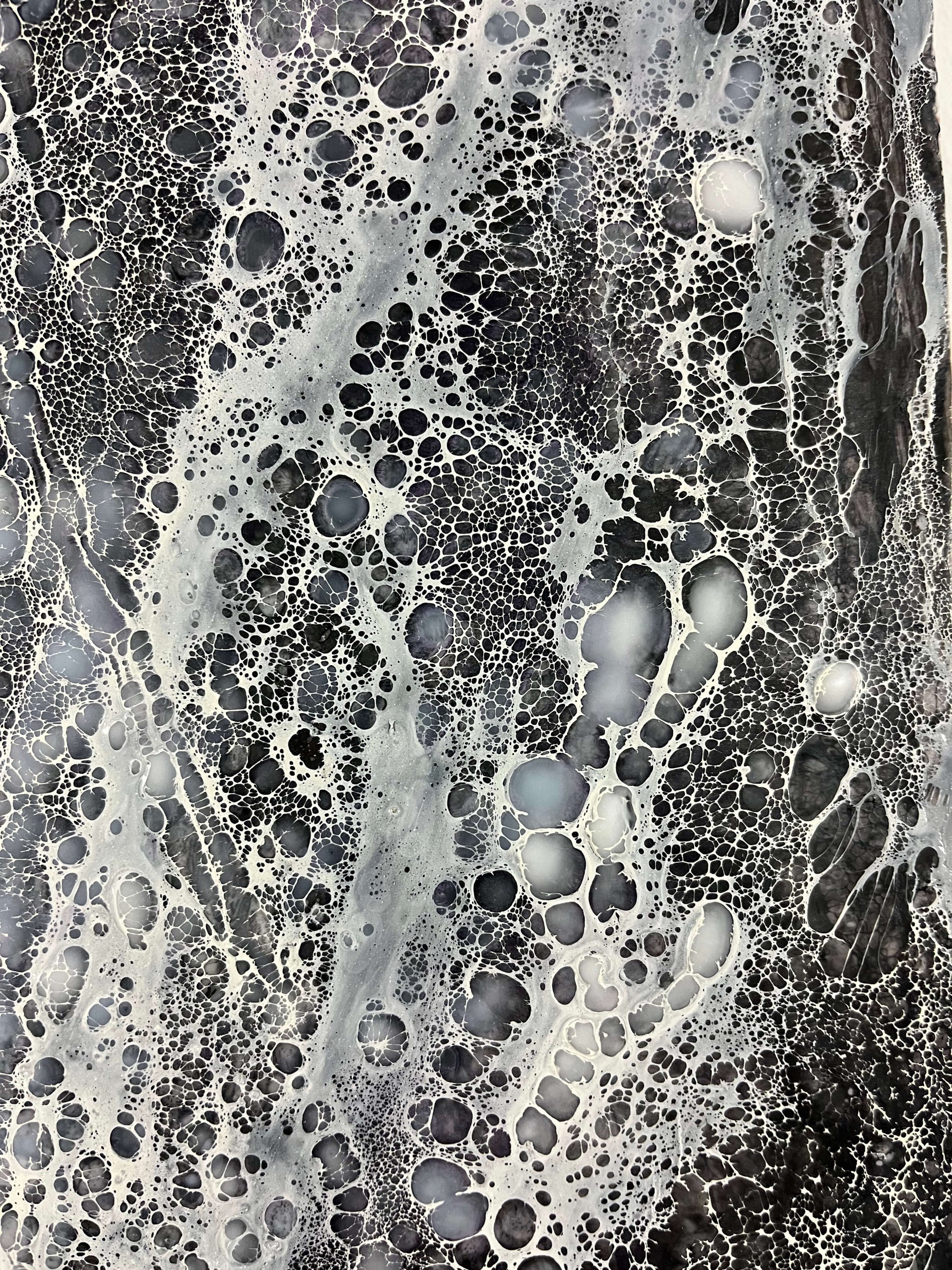 Close up.Abstract Encaustic Painting, 30x40in. Created with beeswax, damar resin, dry pigments and shellac on cradled wood panel. This piece is very striking, it is monochromatic painted in colours varying from black, grey and white. Shellac lace-like cells are burned in a direction that creates movement across the painting. Hanging hardware is included