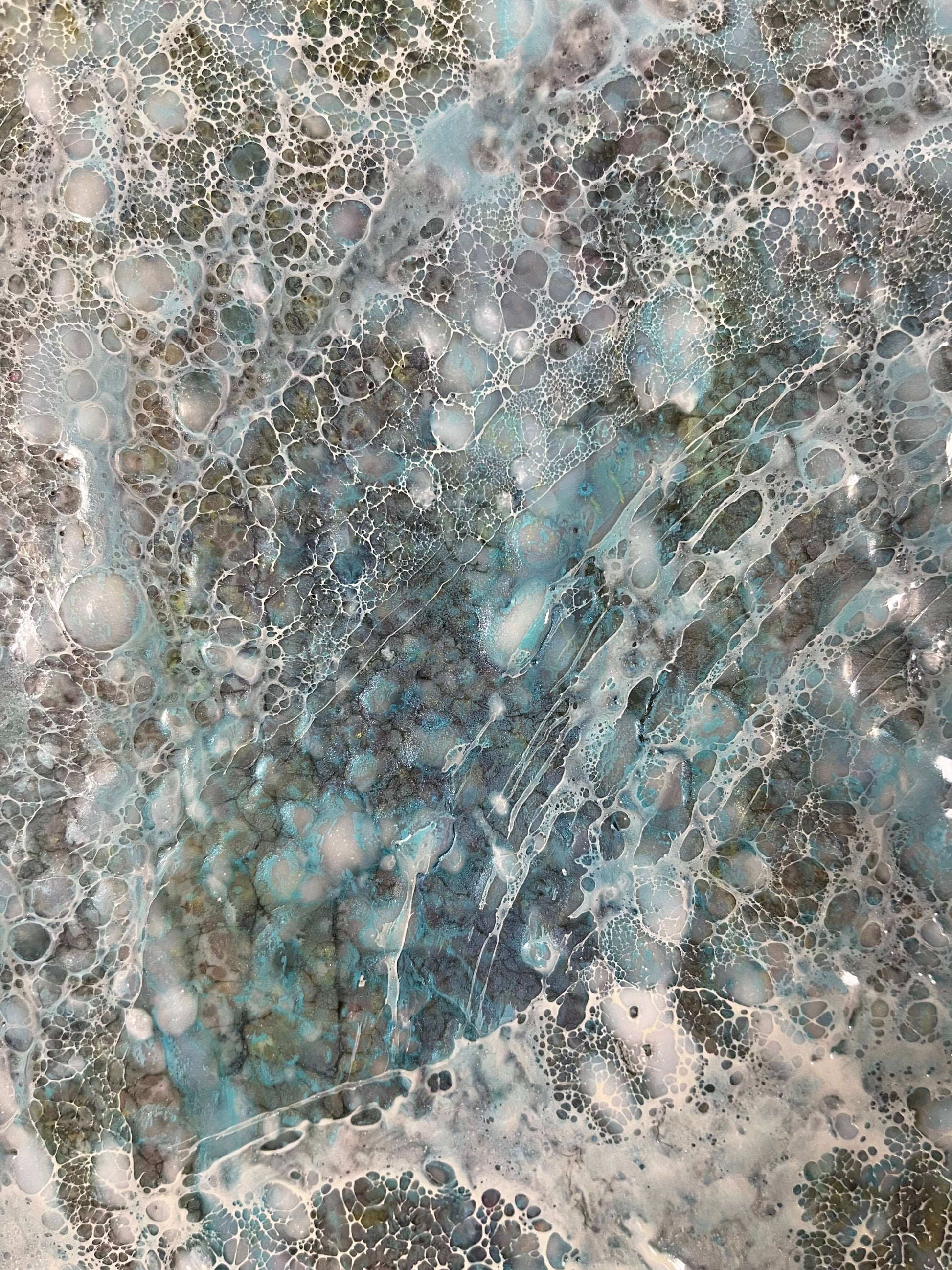 Close up.Abstract Encaustic Painting, 24x30n. Created with beeswax, damar resin, dry pigments and shellac on cradled wood panel. This painting has a very grounding feel to it. With its earthy colours of blue, green, brown and yellow. It is a calm piece with layers of intricate texture created by shellac burn technique. Hanging hardware is included